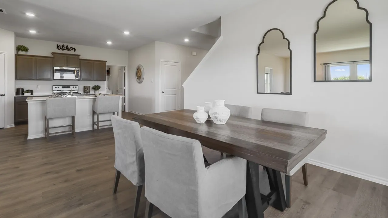 Open-concept dining area featuring wood-finish flooring