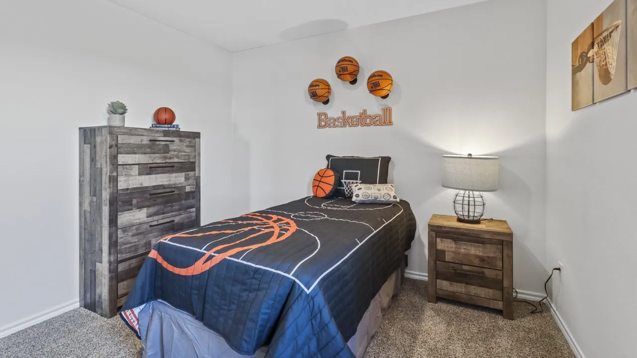 Bedroom featuring light gray walls, carpet flooring, and white baseboards