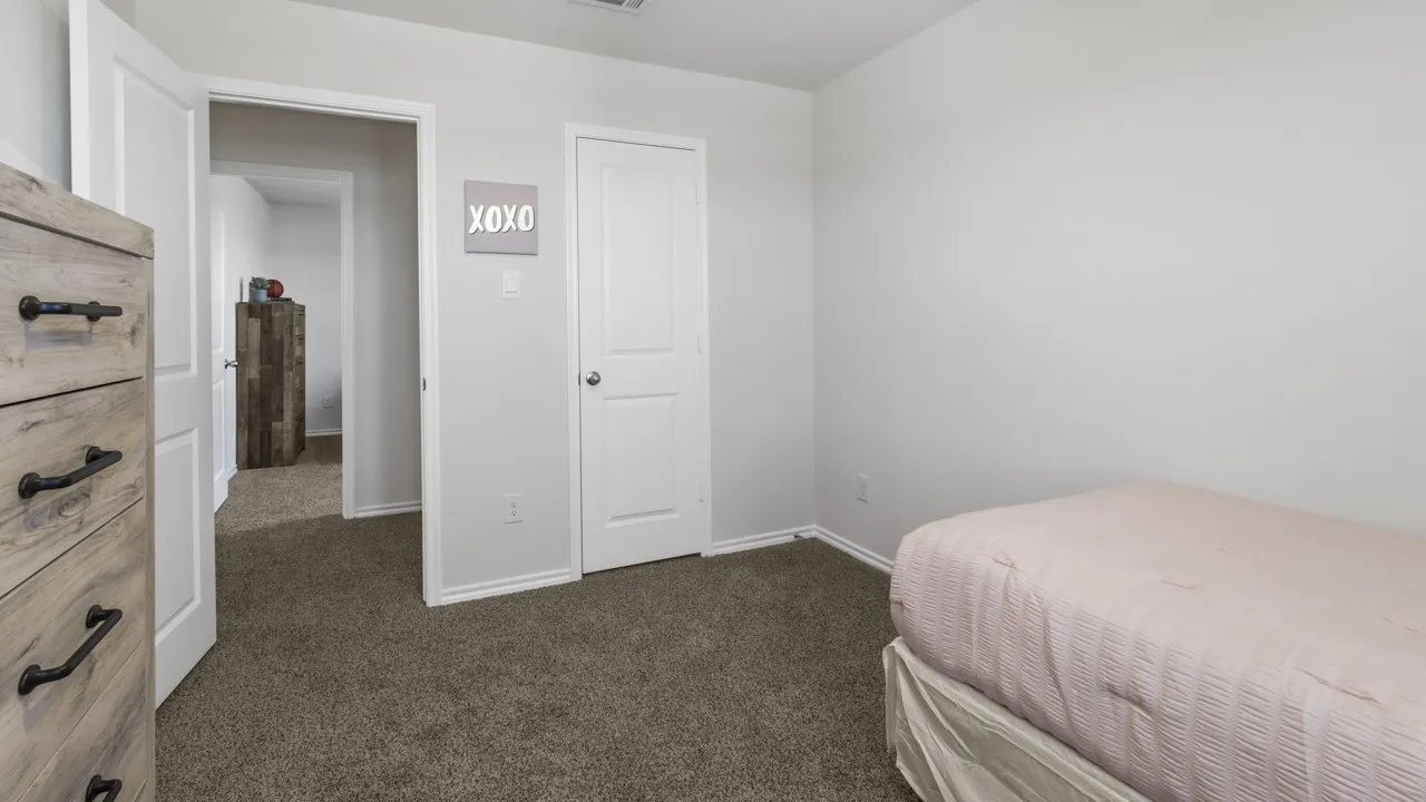 Neutral wall paint complemented by carpet flooring, solid core interior doors, and a baseboard trim