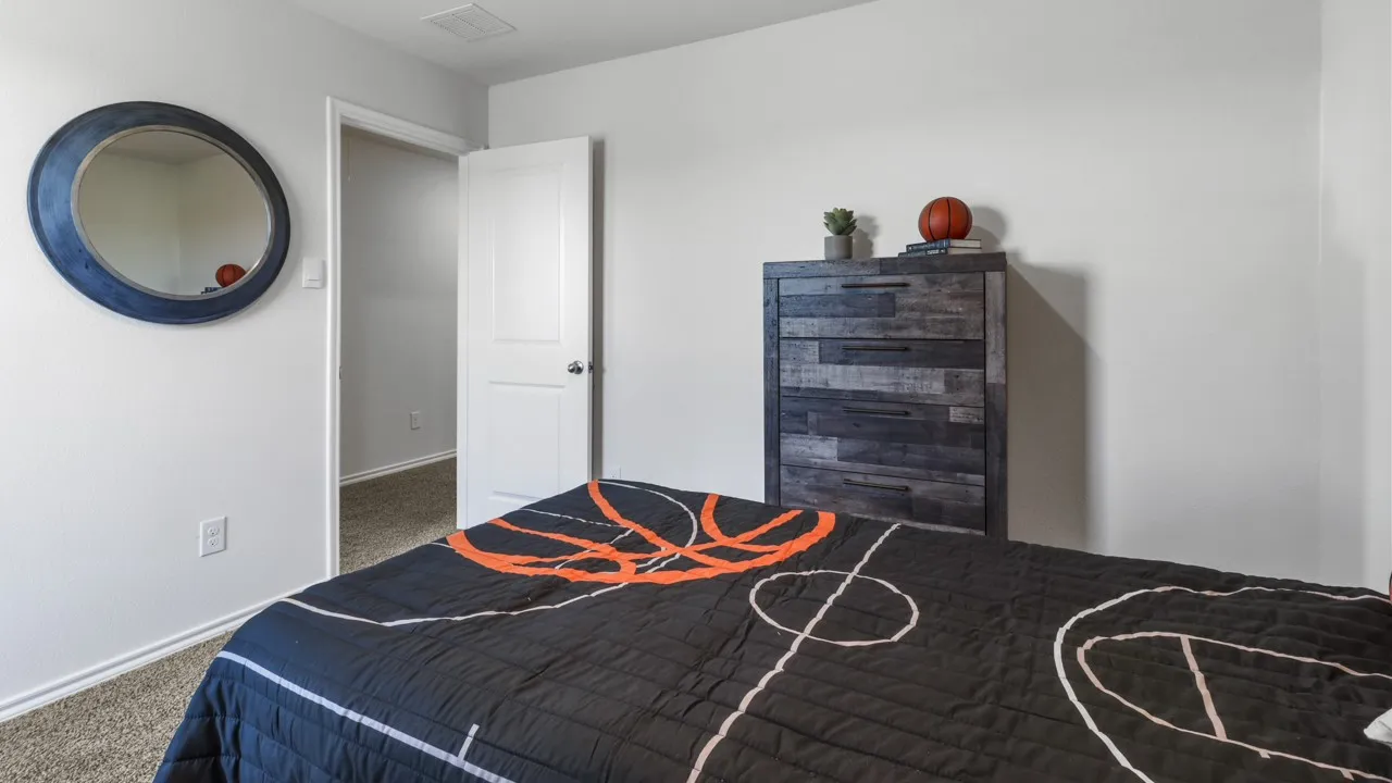 Carpeted room featuring white walls and a white two-panel interior door with a silver-finish knob