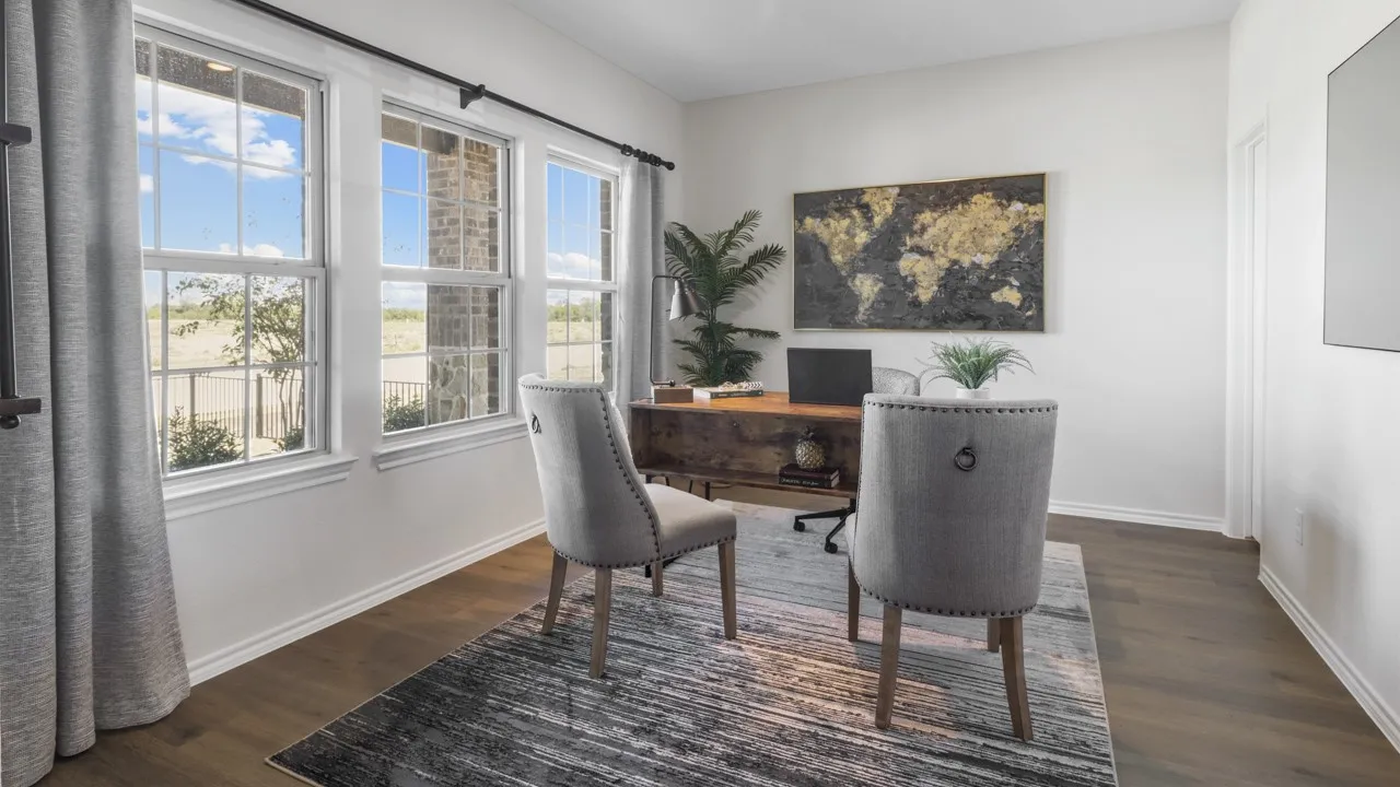 Bright interior space featuring three large windows with grid accents, wood-finish flooring, and crisp white walls