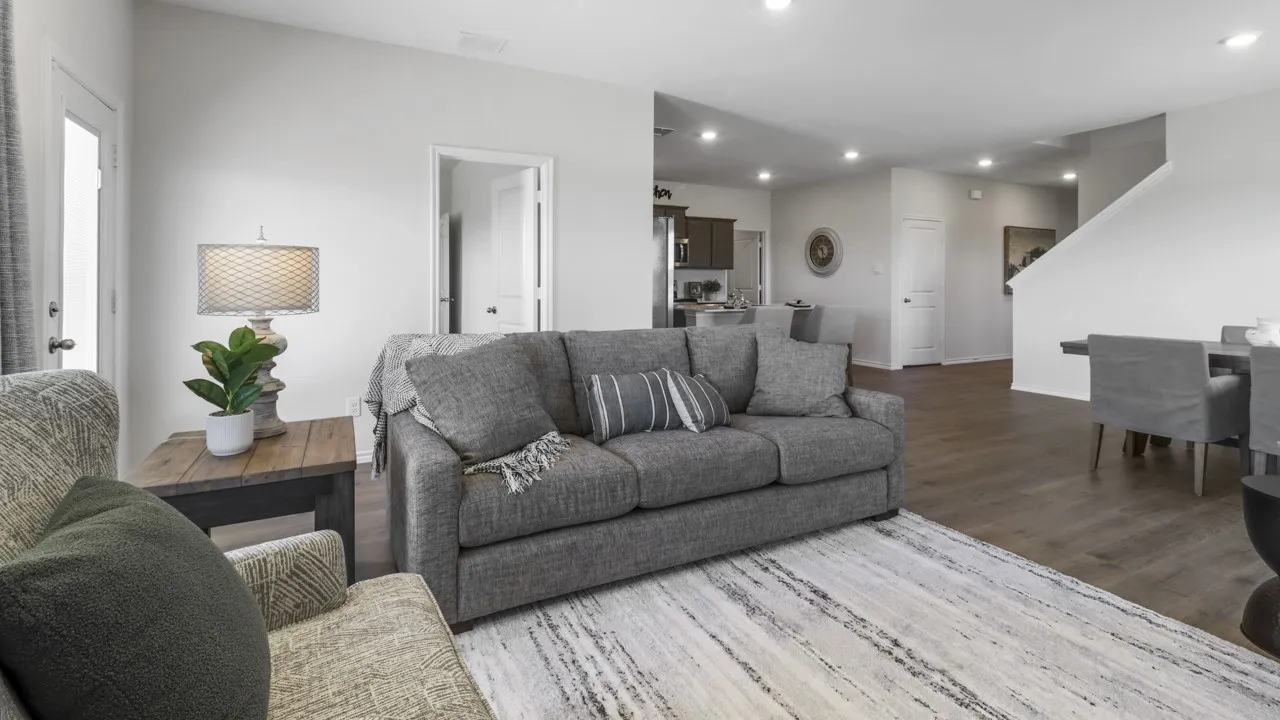 Spacious living area featuring wood-finish flooring, recessed lighting, and light neutral wall colors