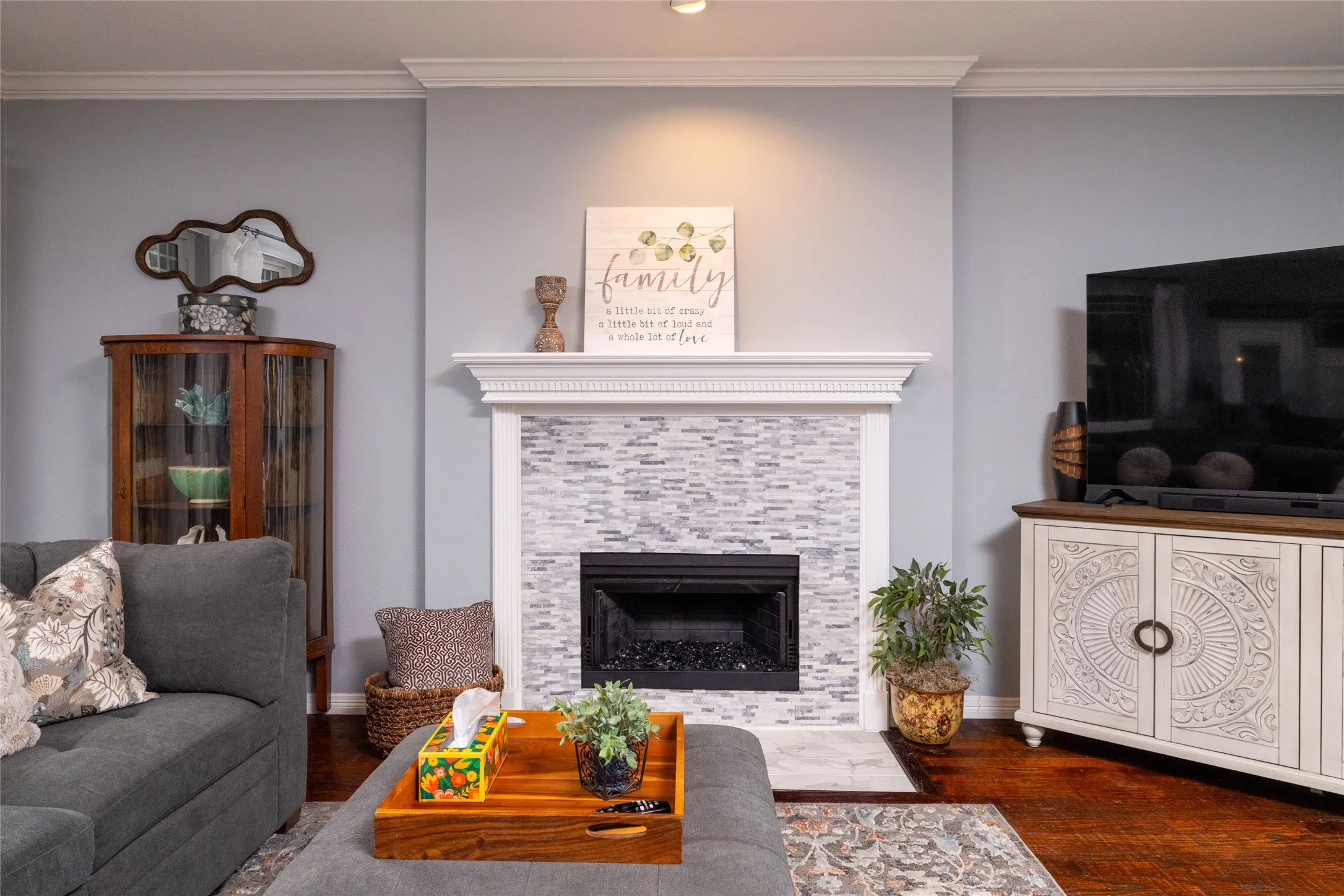 Fireplace featuring a decorative tile surround and white mantel with dentil molding