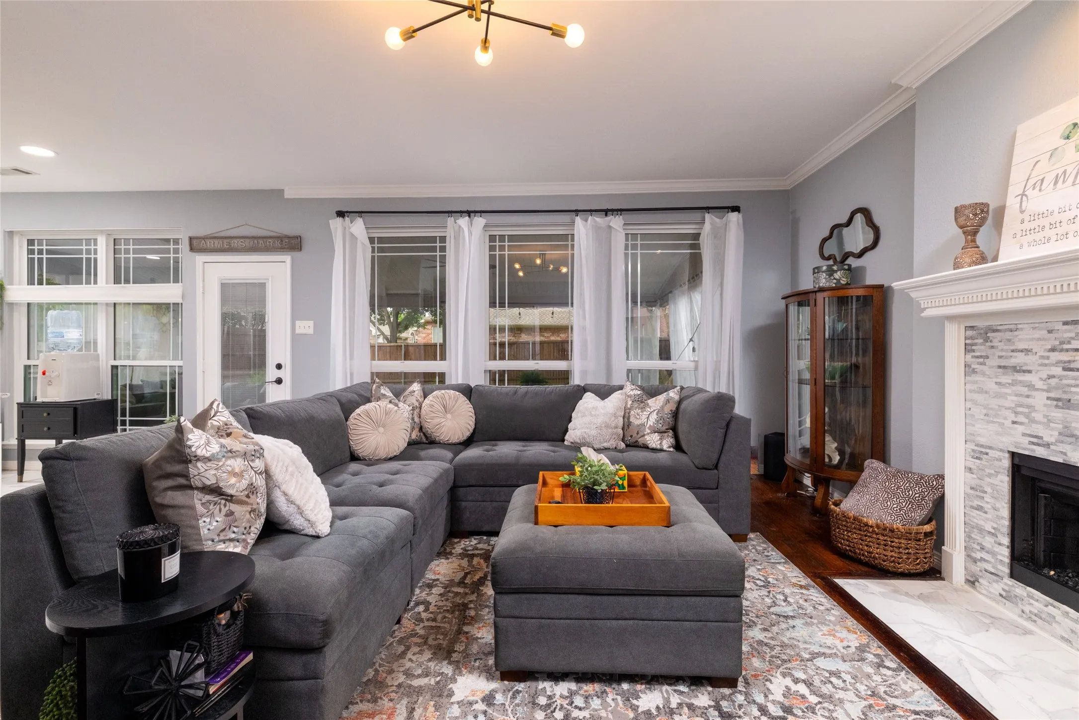 Hardwood-style flooring and light gray walls define this living space
