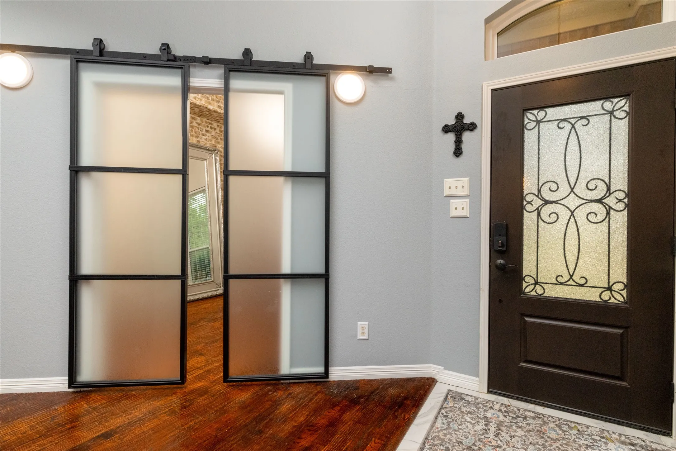 Frosted glass barn doors with black metal framing