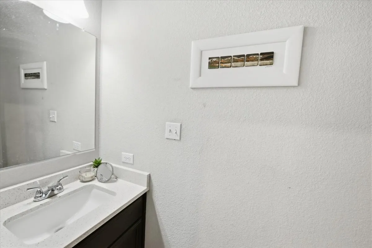 Guest half-bathroom featuring vanity and commode