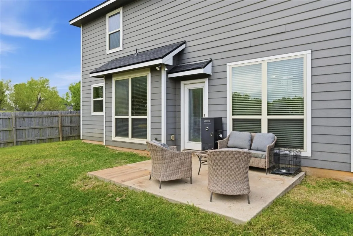Rear view of property with a patio area and outdoor seating
