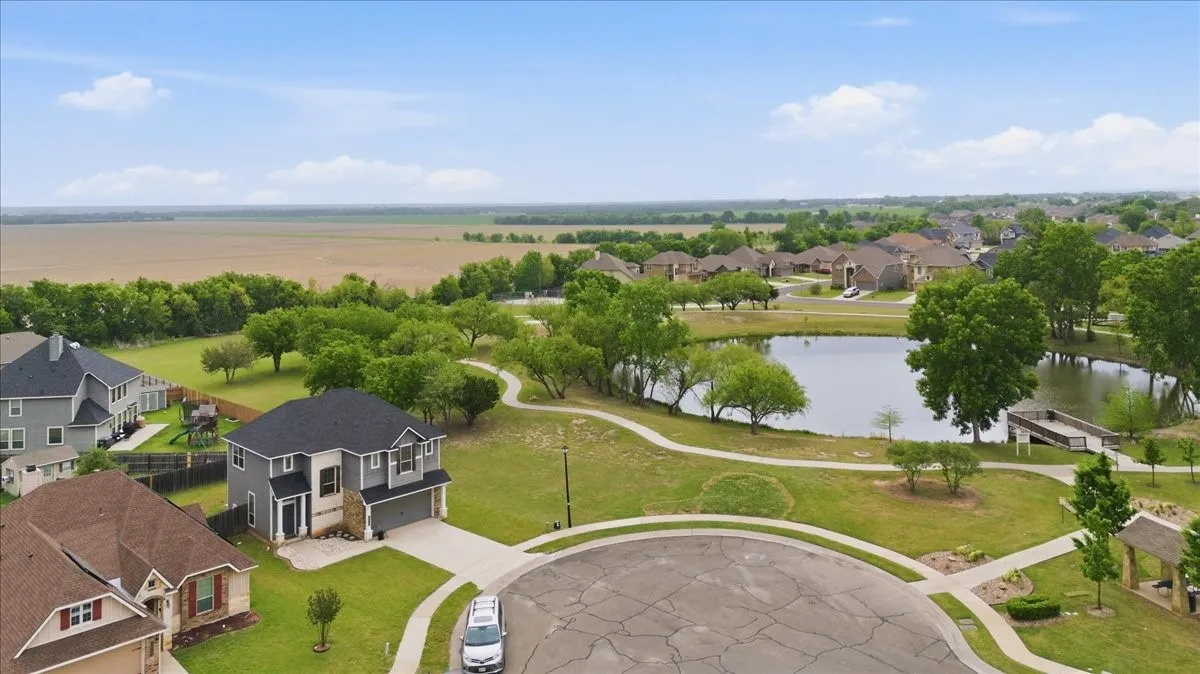 Aerial view of this home next to neighborhood pond/park/walking area