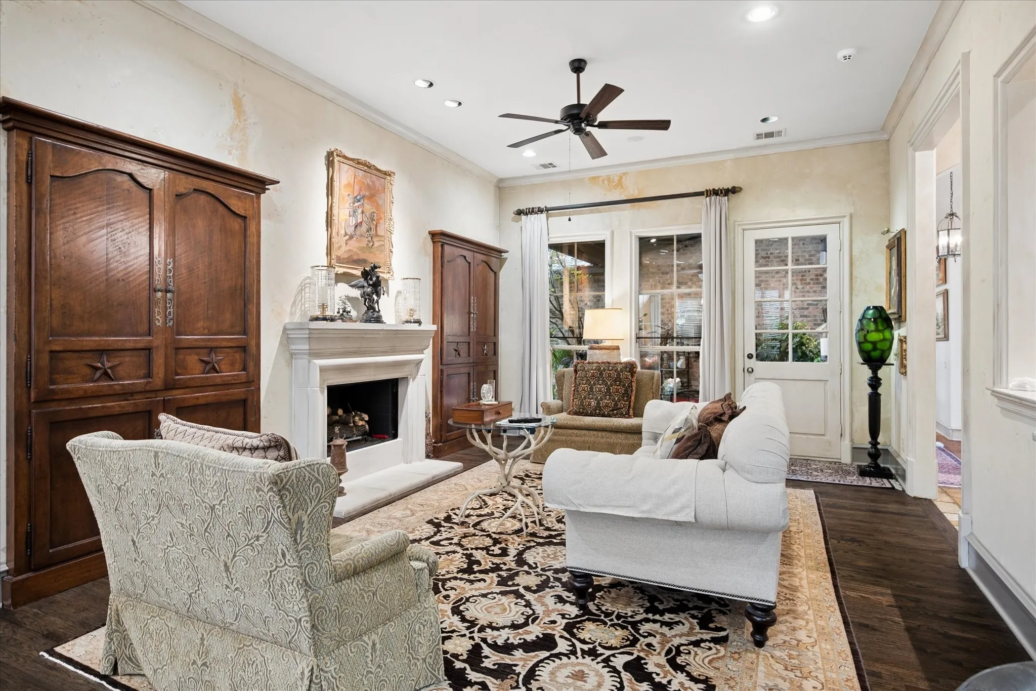 Cast stone fireplace and views of patio