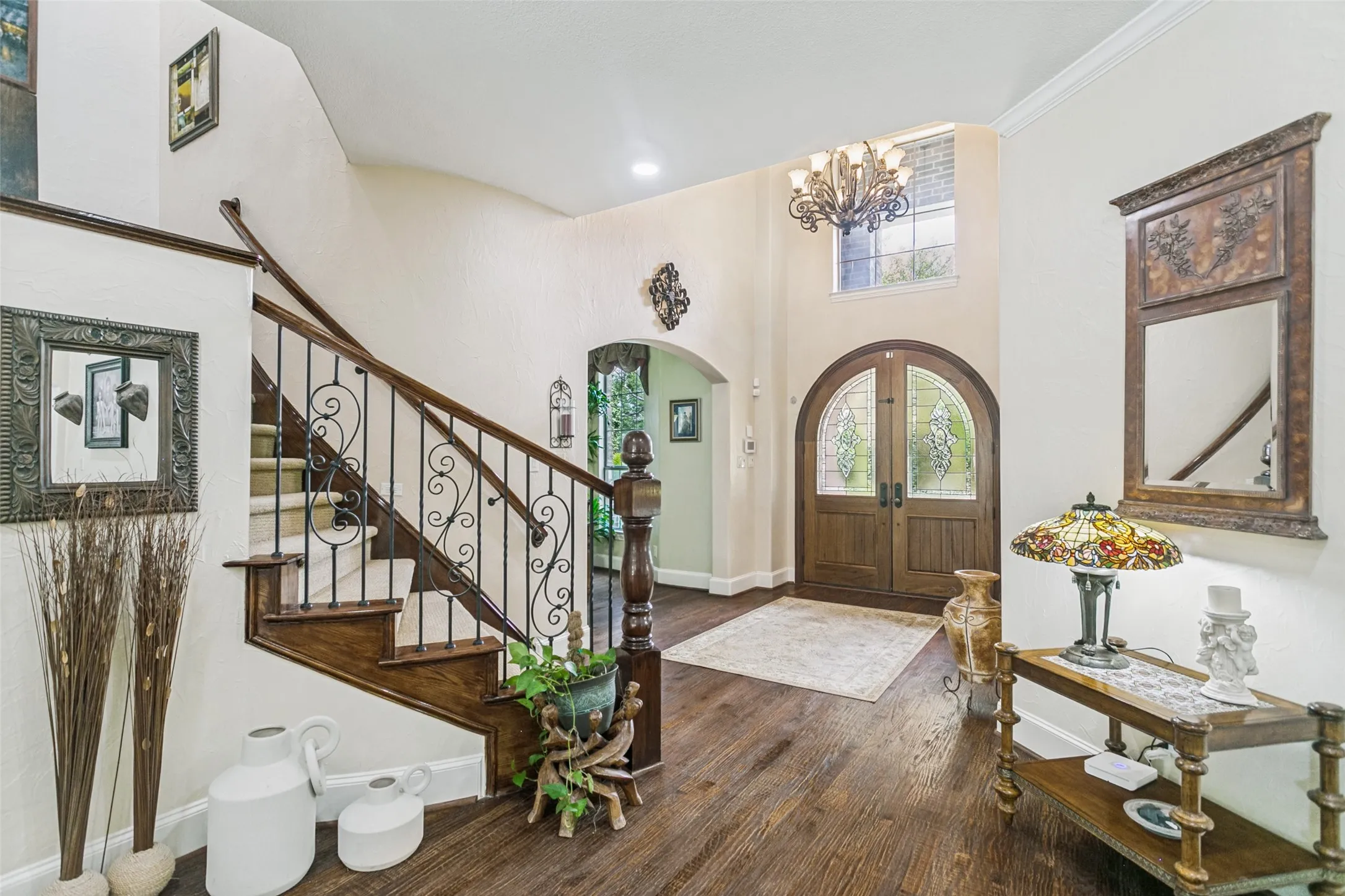 Grand Entrance with Sweeping Staircase and Beautiful Arched Doorway