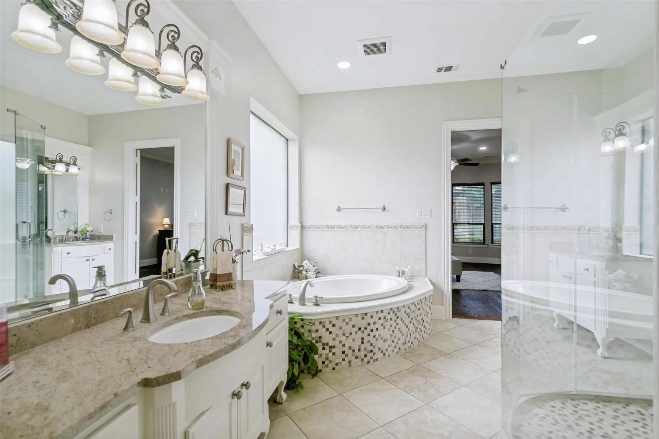 Primary Bathroom with Custom Tile, Oversized Shower, Separate Soaking Tub and Split Vanities