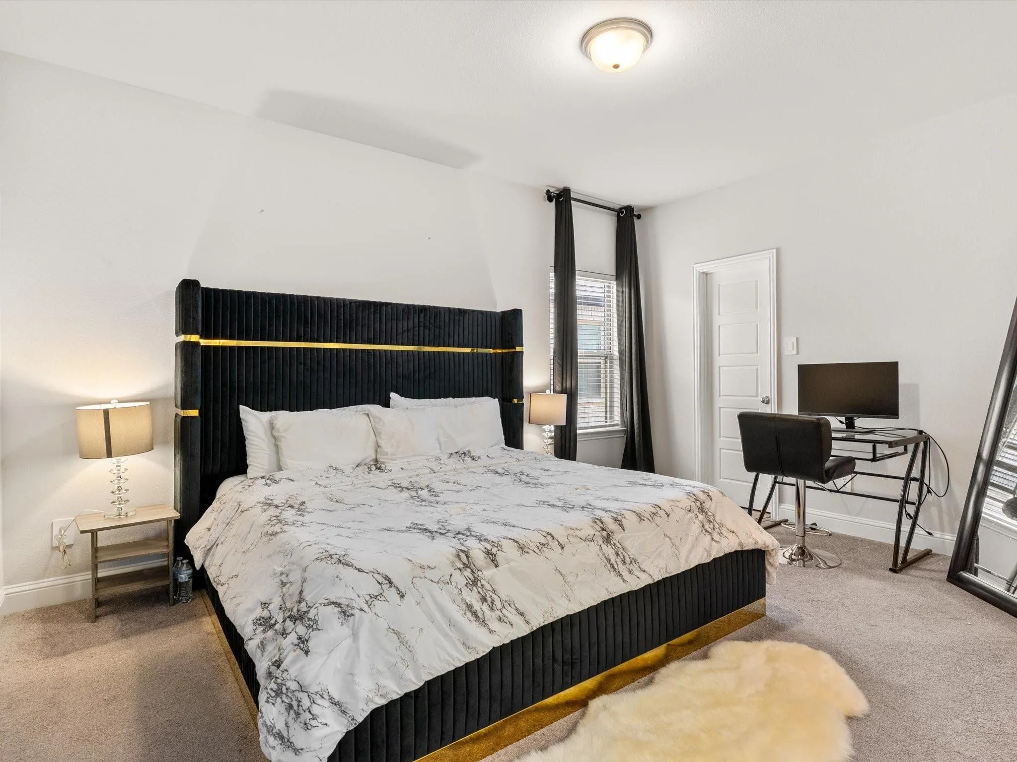 Bedroom featuring light gray wall paint, a single window with blinds and dark drapery, a white paneled door, and recessed lighting