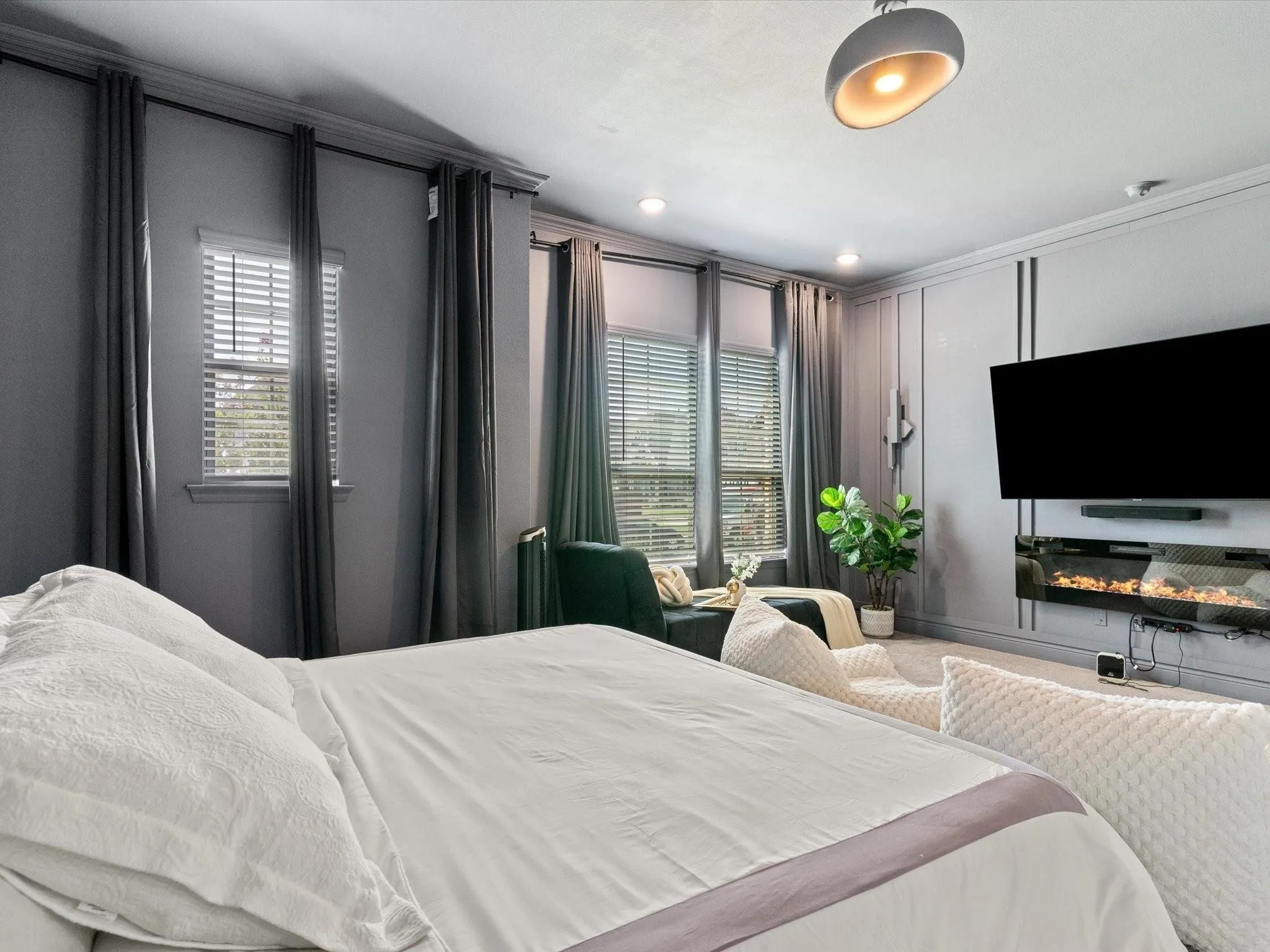 Spacious interior with multiple windows featuring blinds and drapery