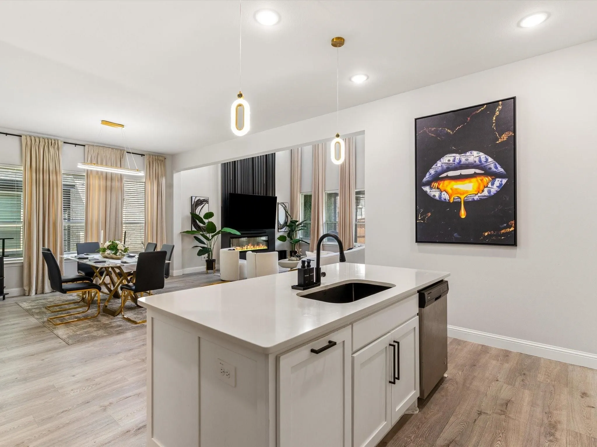 Kitchen island featuring a white countertop, undermount sink, and black faucet