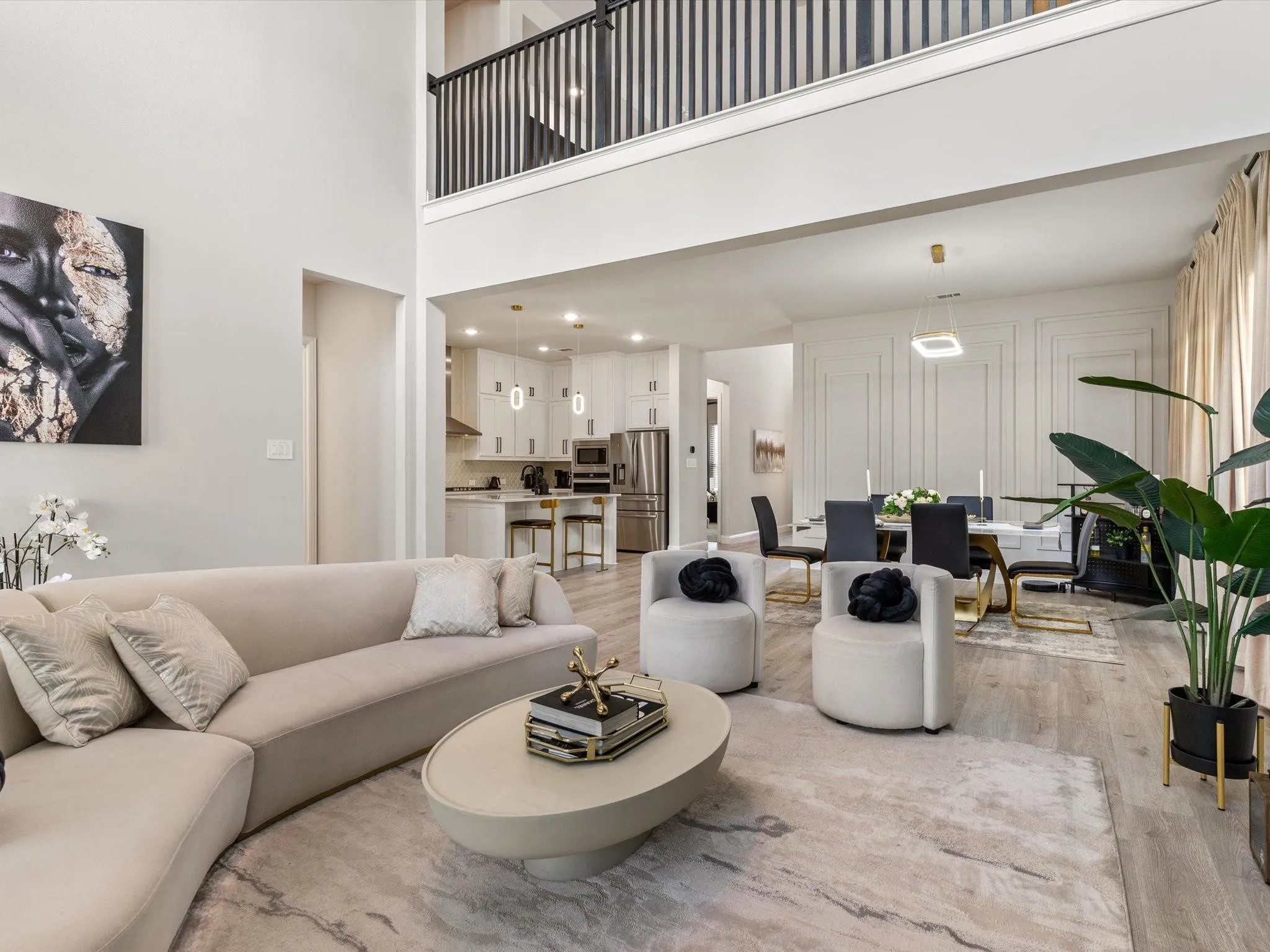 Open-concept living space featuring high ceilings and wood-finish flooring