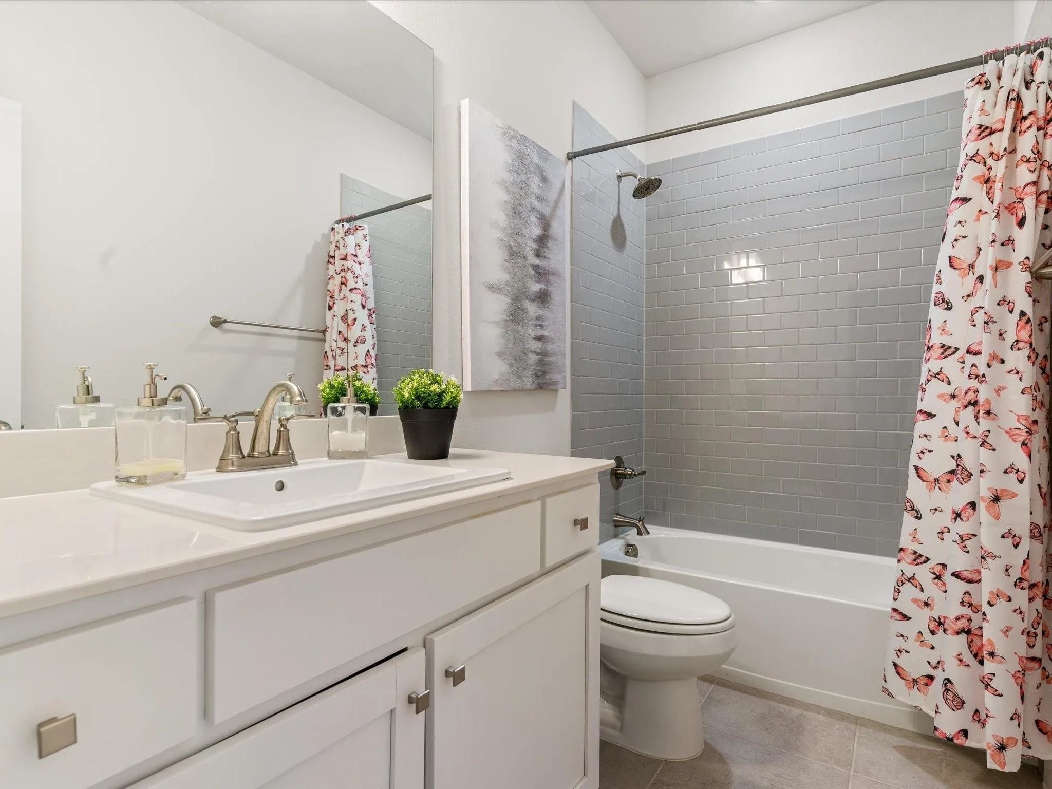 Bathroom featuring a white vanity with recessed panel cabinetry, a white rectangular sink, and a silver-toned faucet