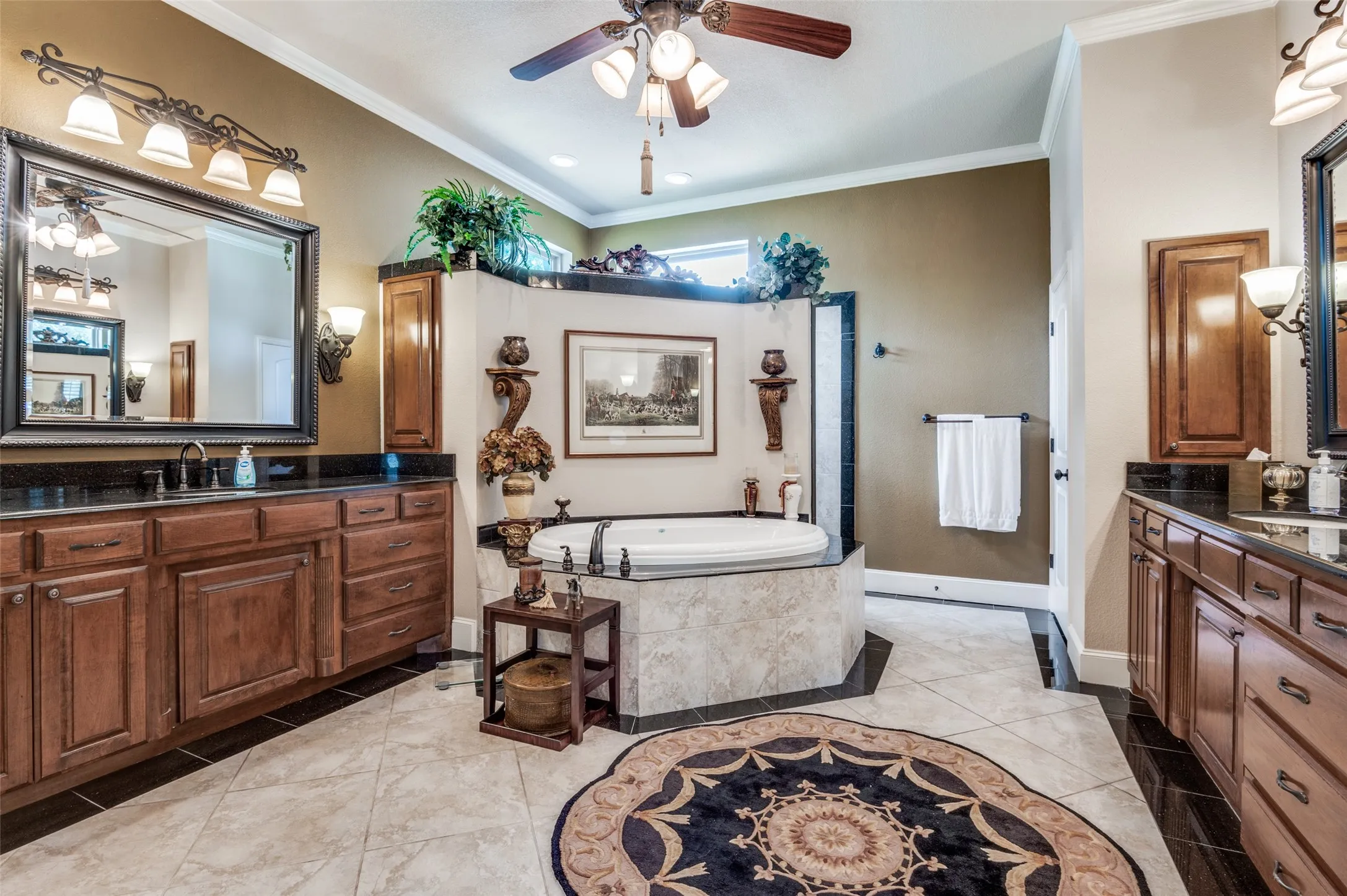 Ensuite primary bathroom. Shower behind garden tub, double vanities with ample storage! Tile flooring throughout, fan, crown molding! Just off this bathroom is a very spacious walk in closet with built ins!