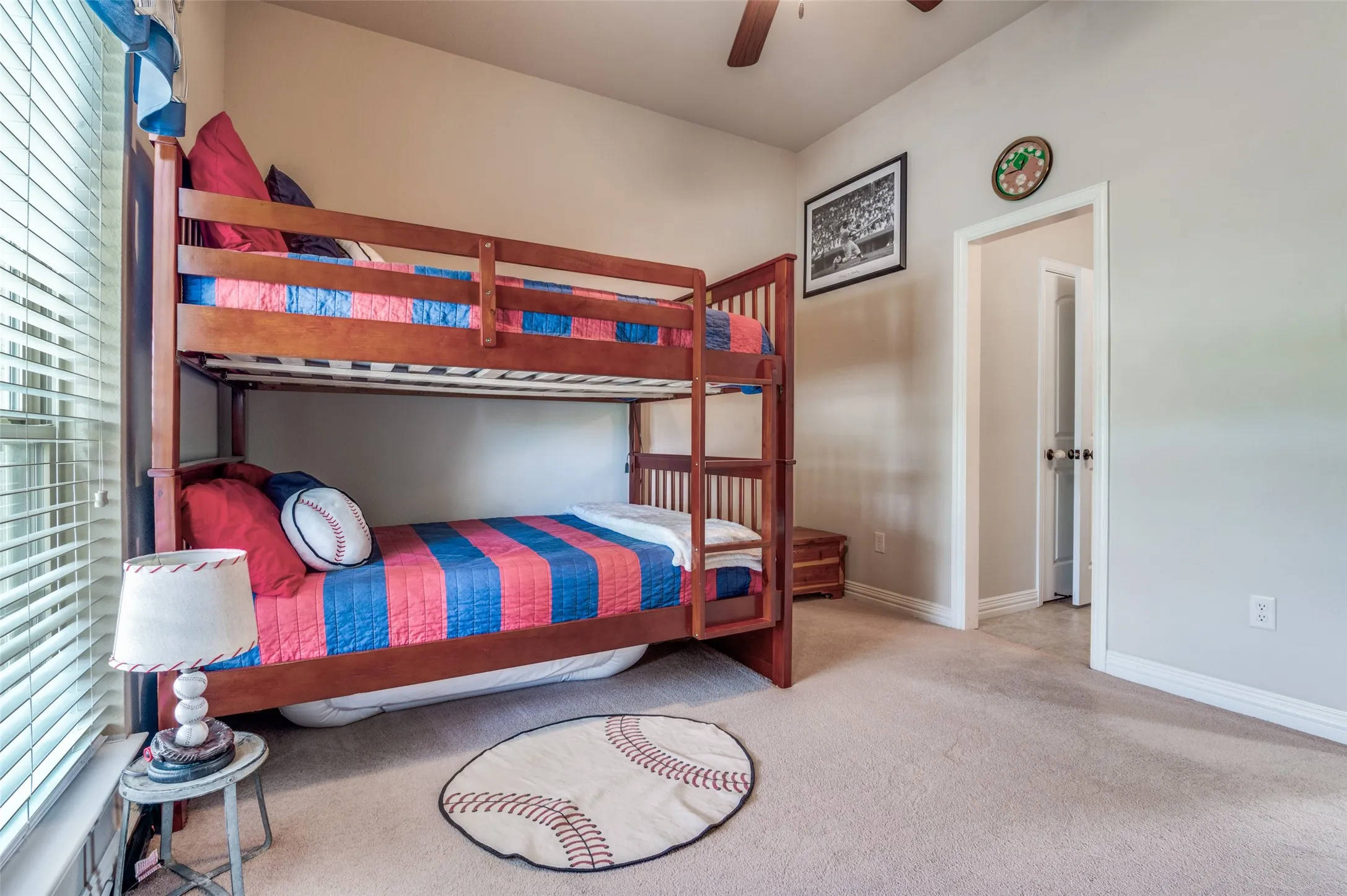 One of the secondary bedrooms with private vanity area, big closet, fan, two inch blinds and front yard views!