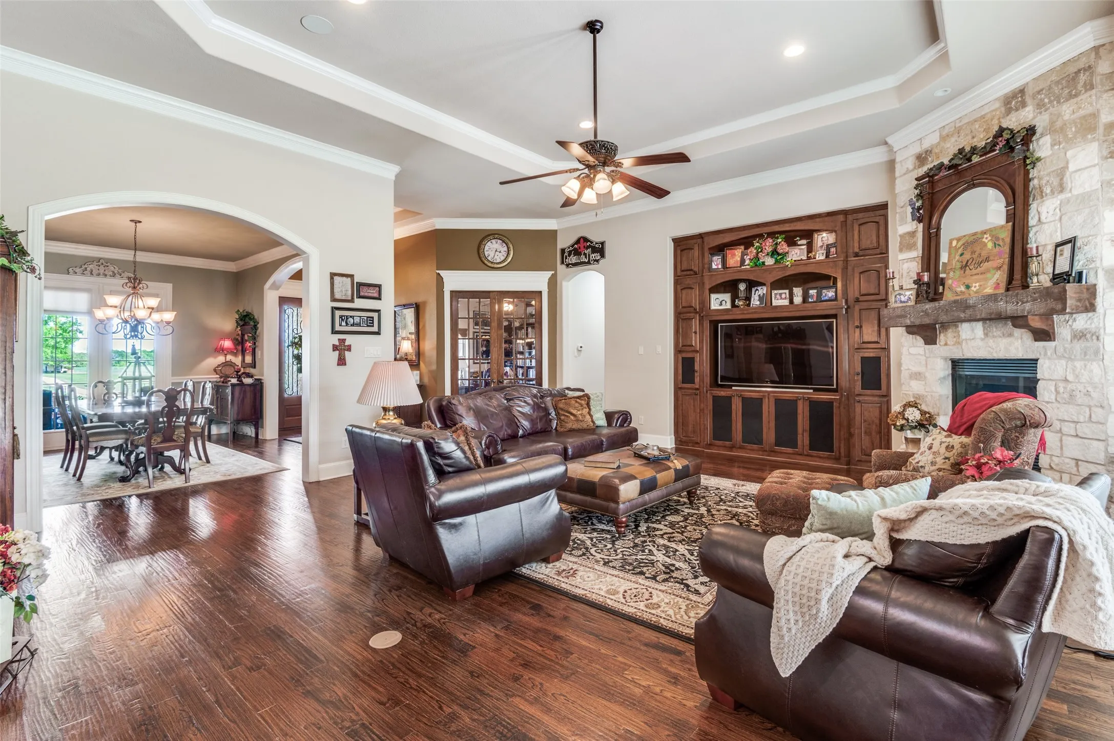 Hand scraped hardwoods, spacious dining, custom front door, closed private office, stone fireplace, built ins, floor plugs and custom trim work!