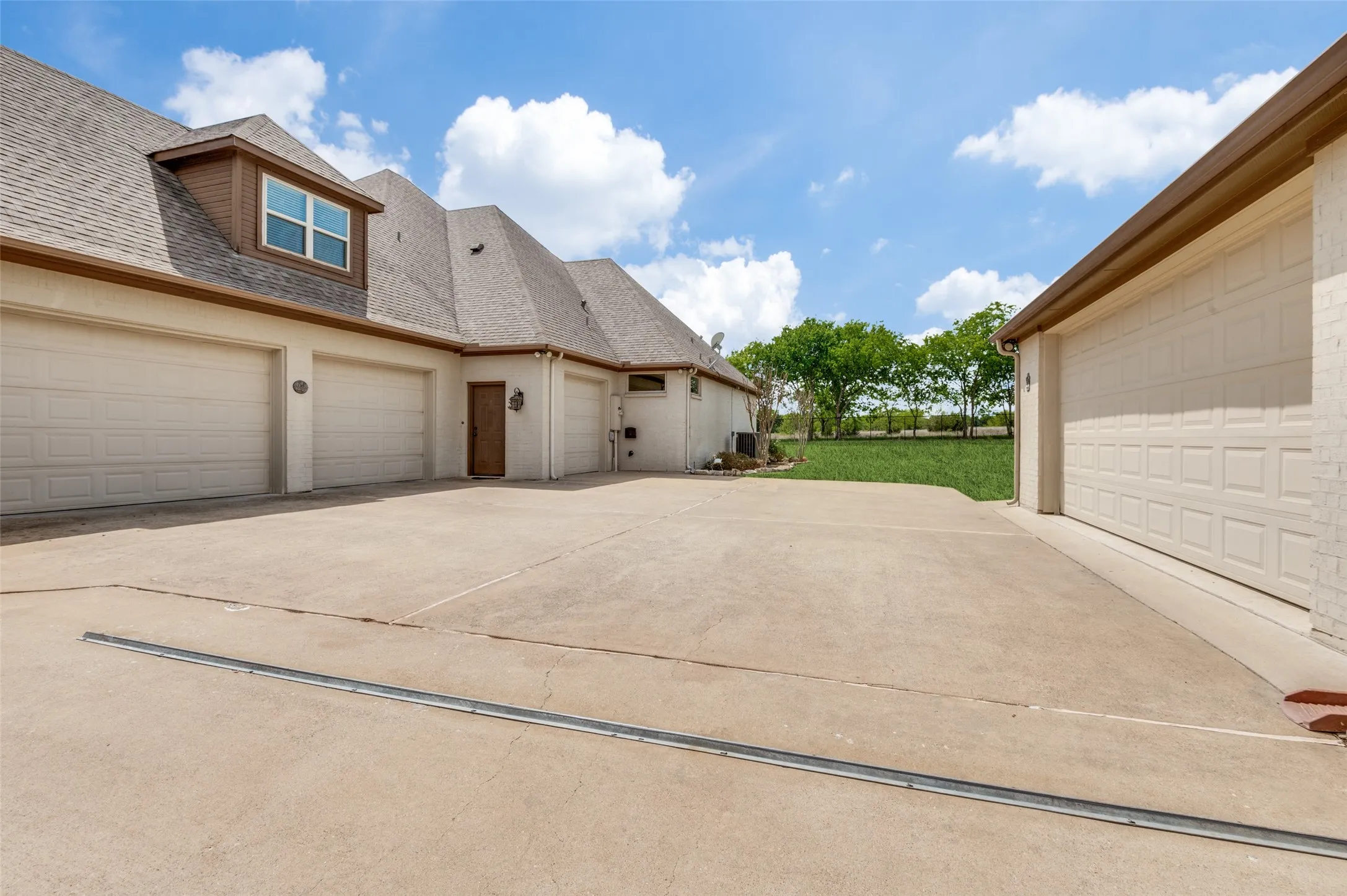 Garage storage for days!  Two car attached offers big workshop, pass through door, large storage closet, built in cabinets.  Two car detached is oversized and allows for a lot of storage as well as parking 2 cars!  This area is behind an electric gate providing extra security!