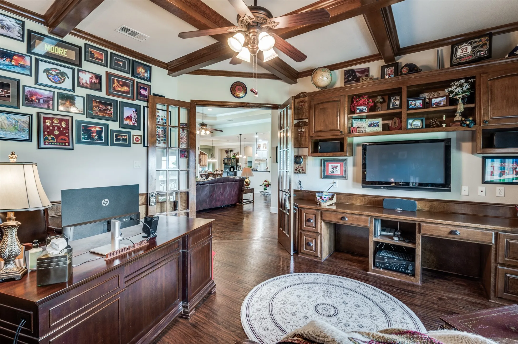 Private study with French style doors, coffered ceilings, built ins and views of front garden.