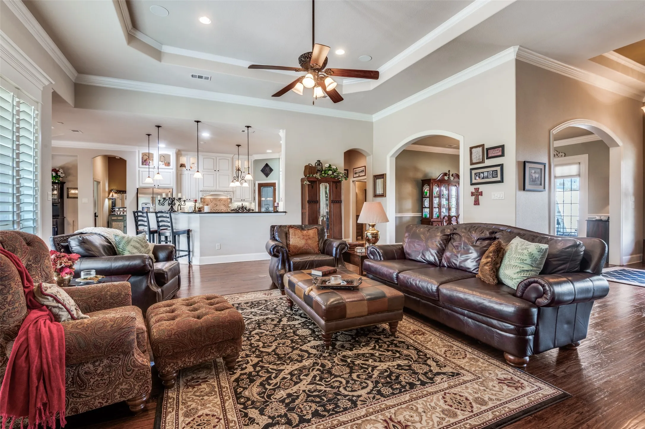 Plantation blinds, custom trim work, open and inviting living room!