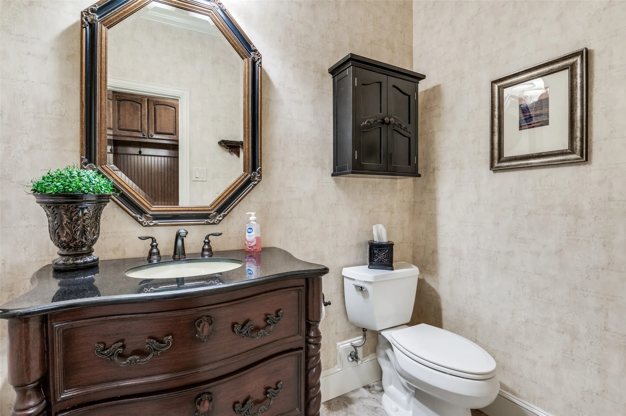 Good size half bath for guest just off the hall to the garage and mud room area!