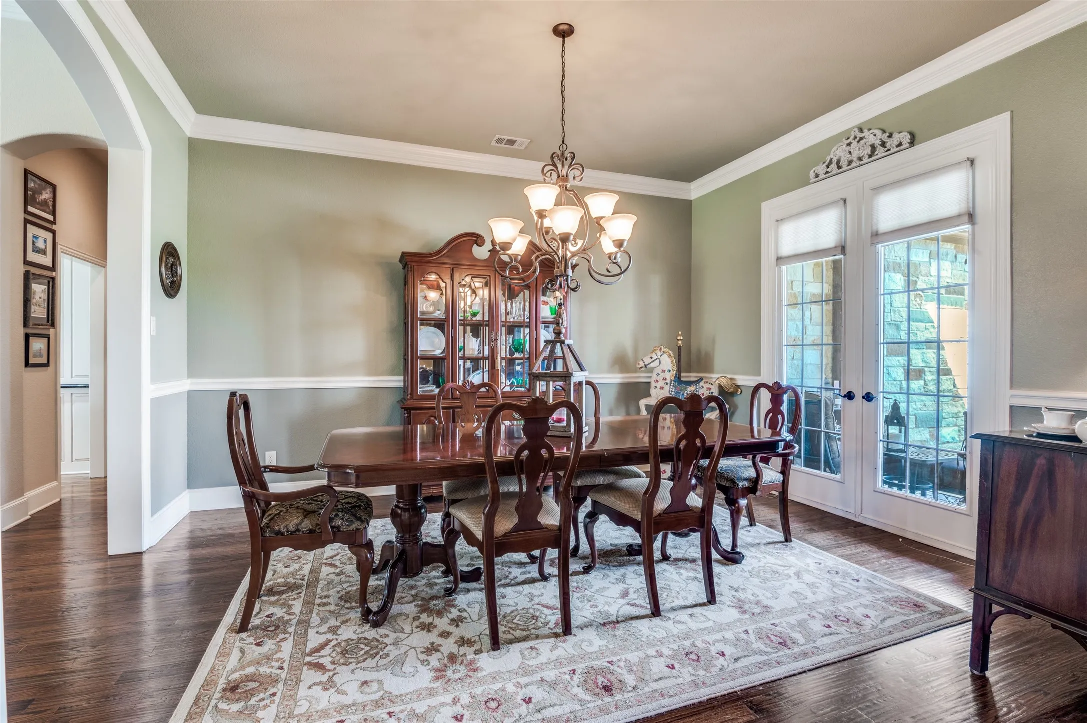 Formal dining with doors that open to front porch! Crown molding throughout. Lots of space for buffet and china cabinet. Located off entry and quick access to the kitchen.