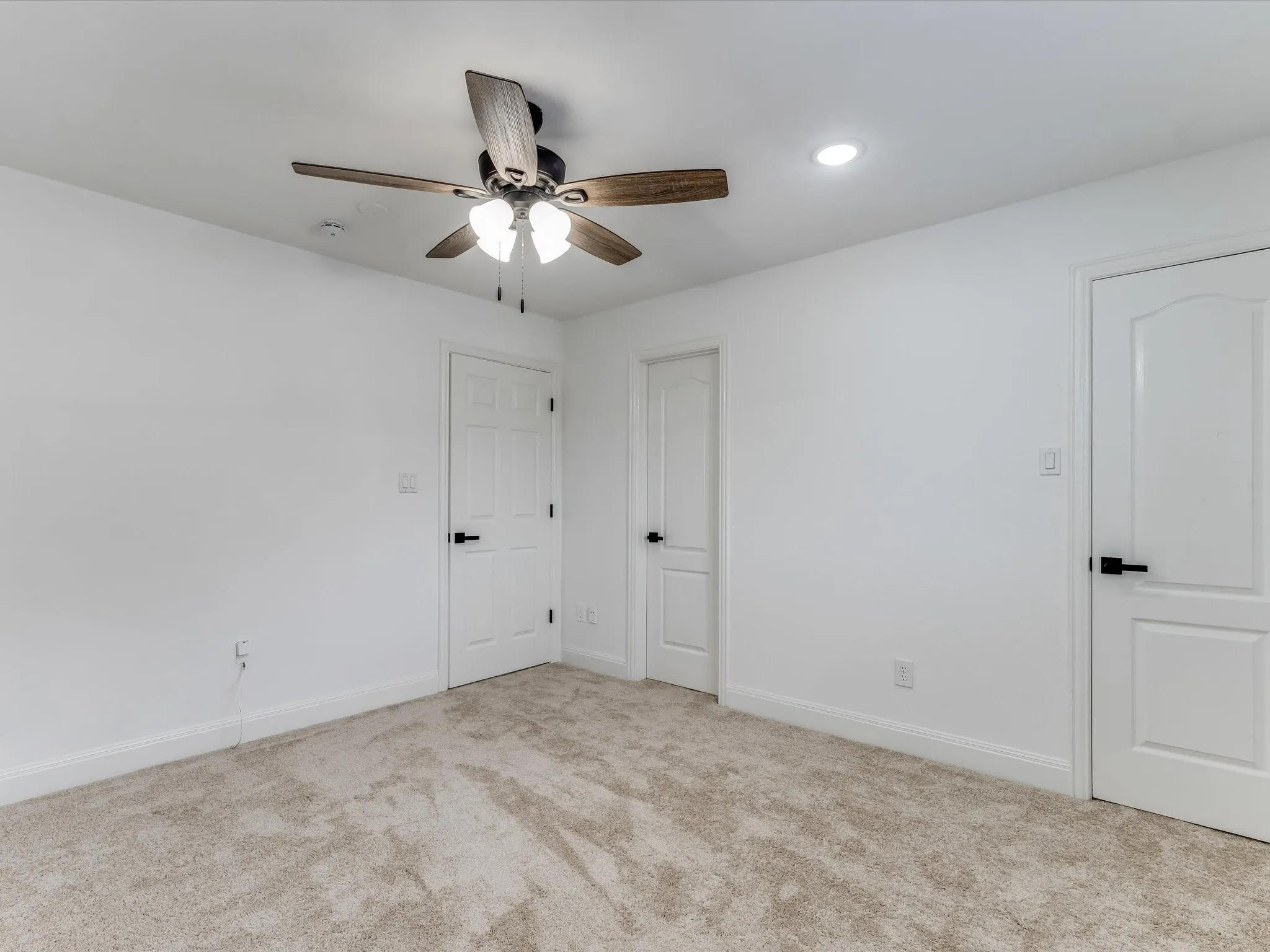 Neutral-toned carpeting paired with crisp white walls