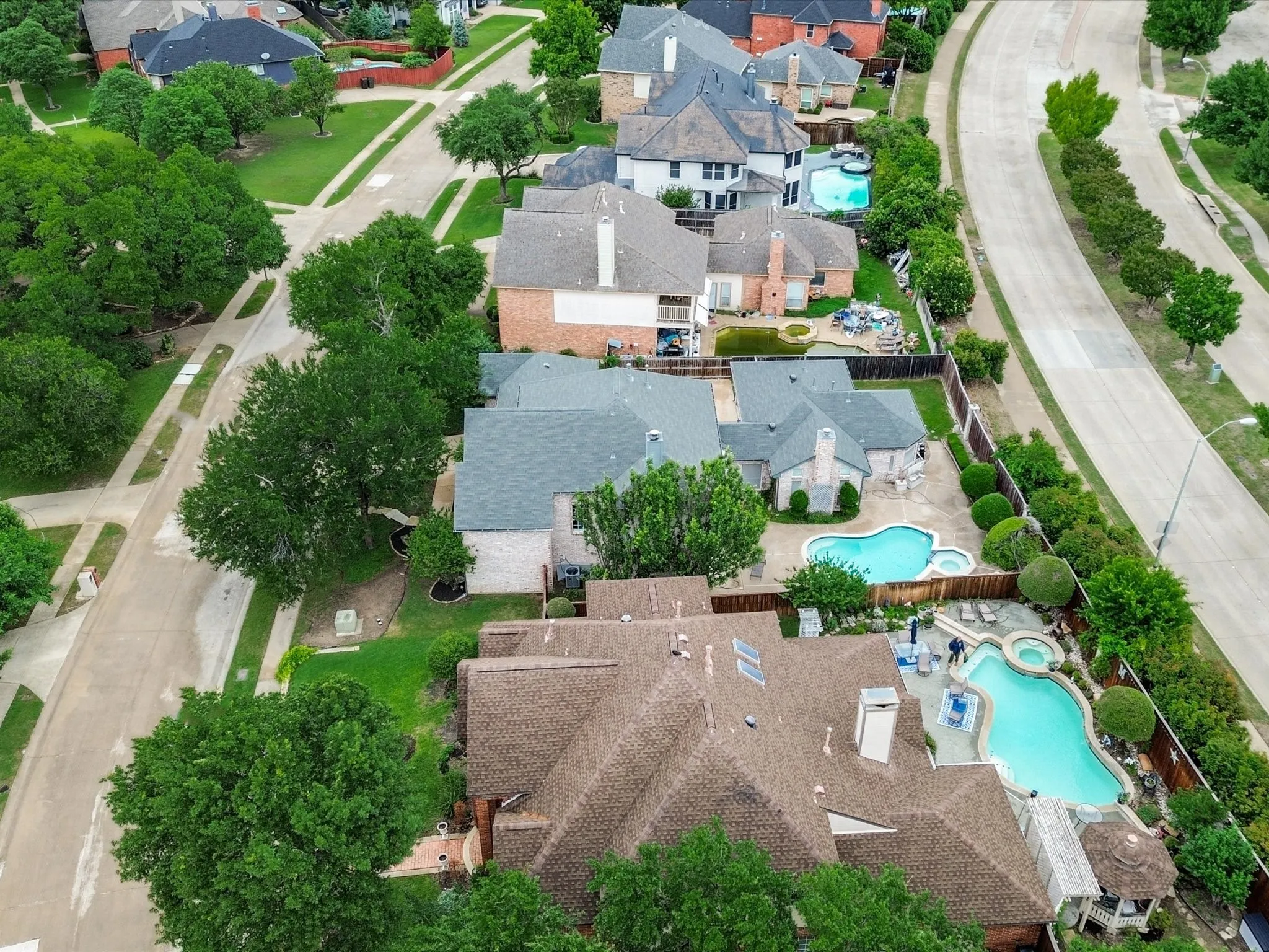 Residences featuring private pools, patios, and mature landscaping