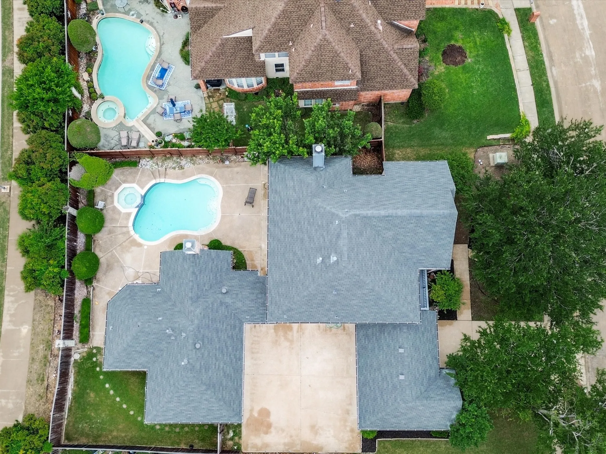 Expansive backyard with a freeform swimming pool and integrated spa