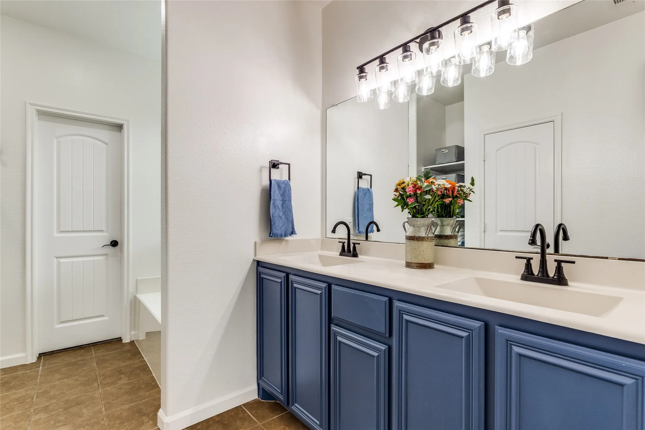 Primary bath with roomy garden tub and linen closet.
