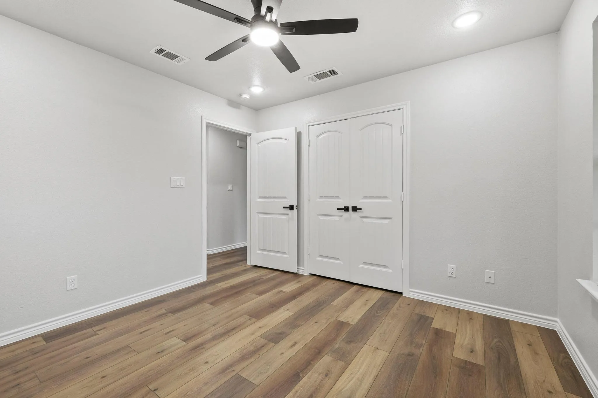 Neutral wall tones complement wood-finish flooring