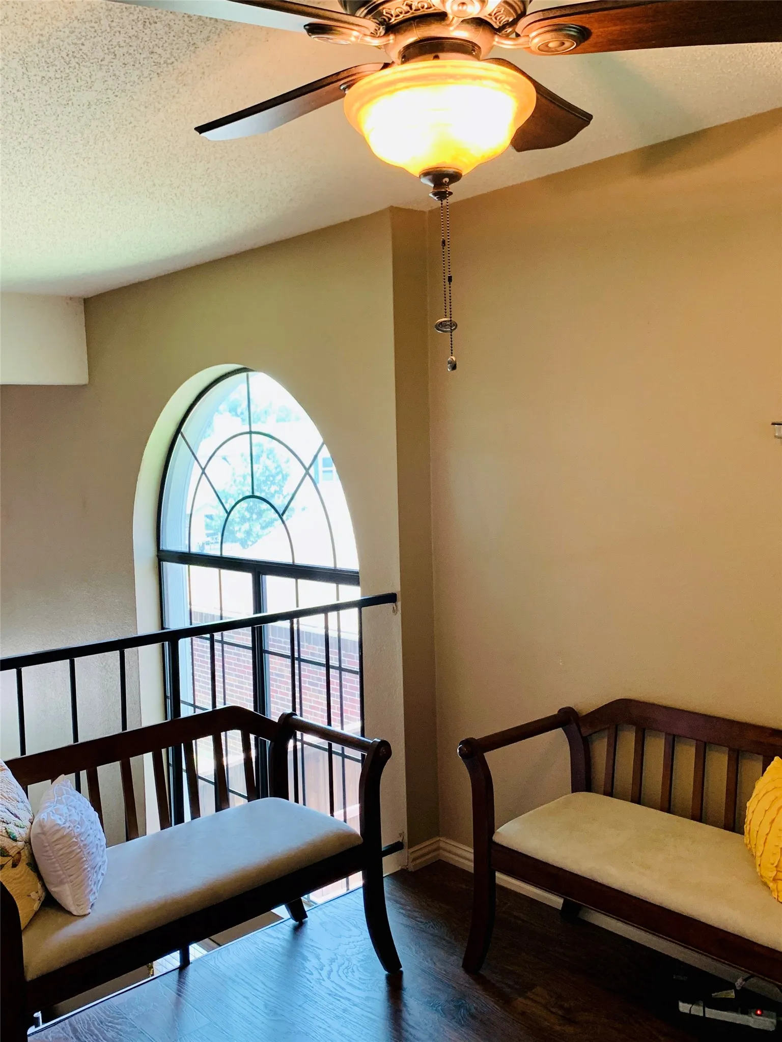 Arch-top window with dark framing and grid pattern