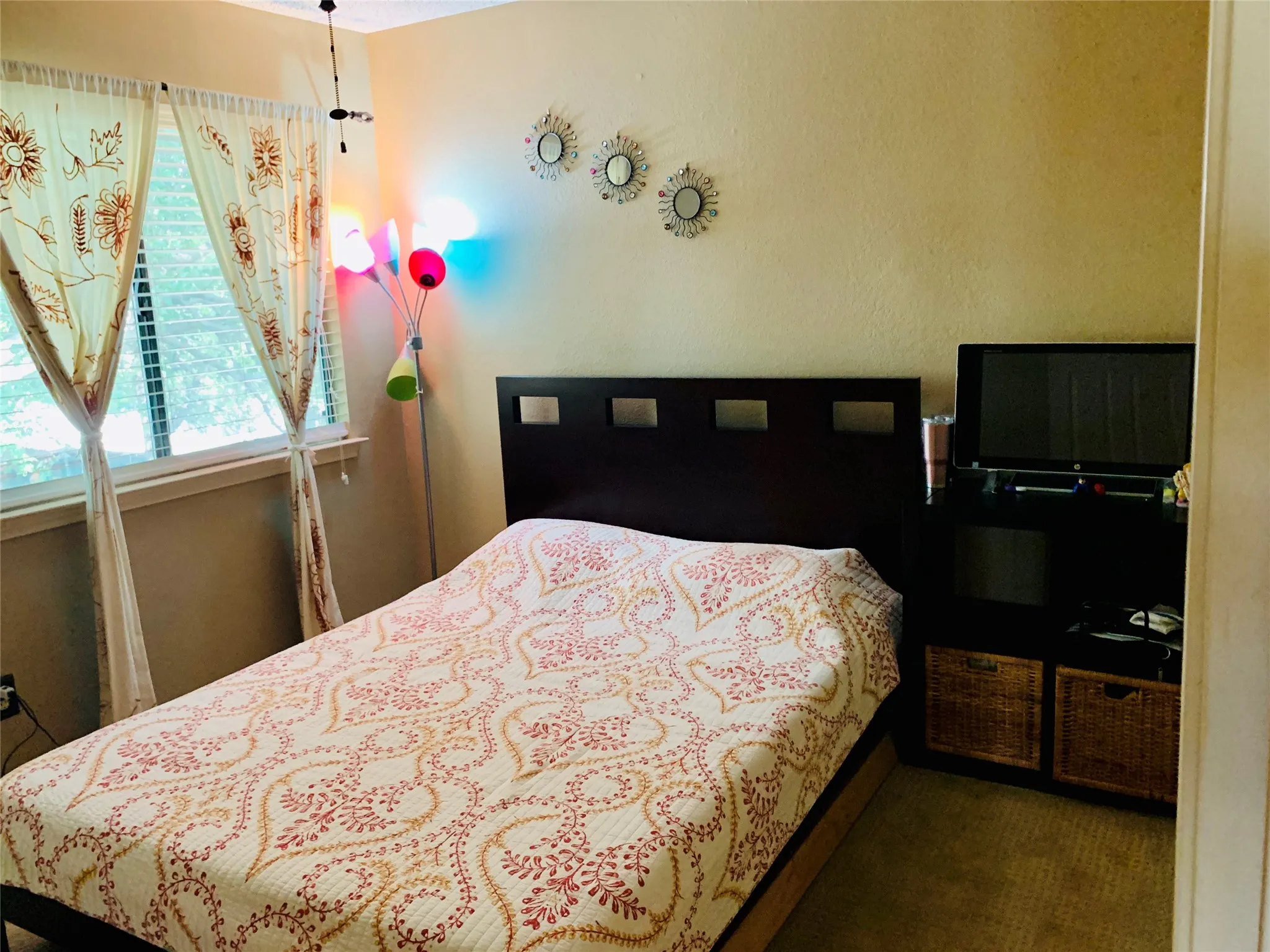 Bedroom with window featuring horizontal blinds, and a built-in shelving unit