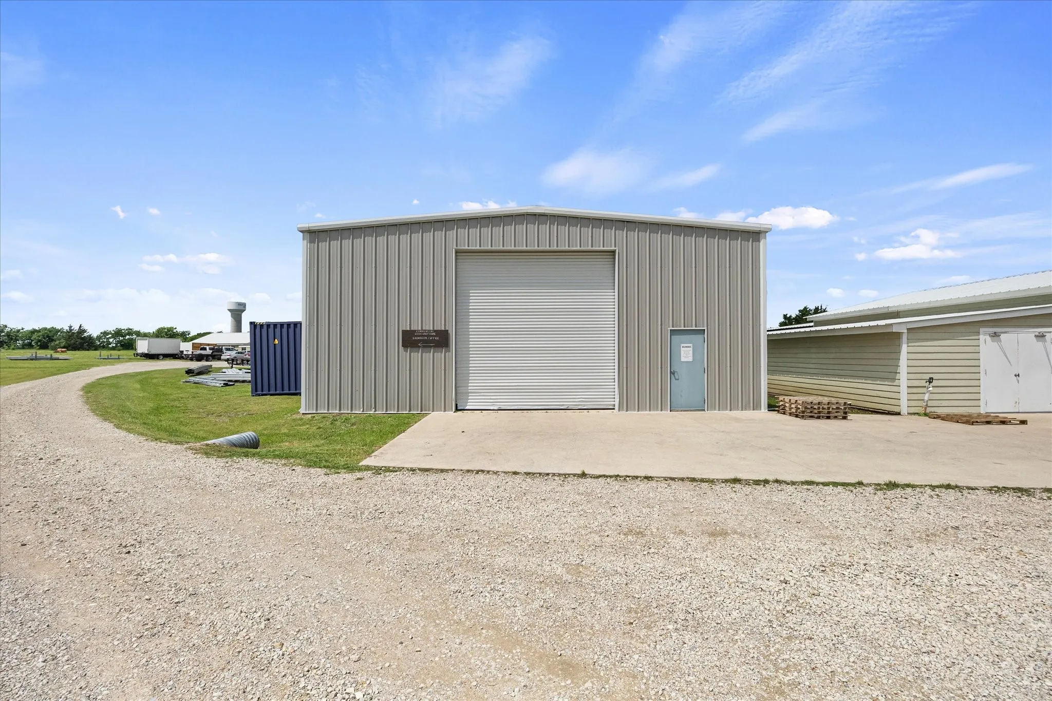 Metal building includes two over head doors and concrete pad