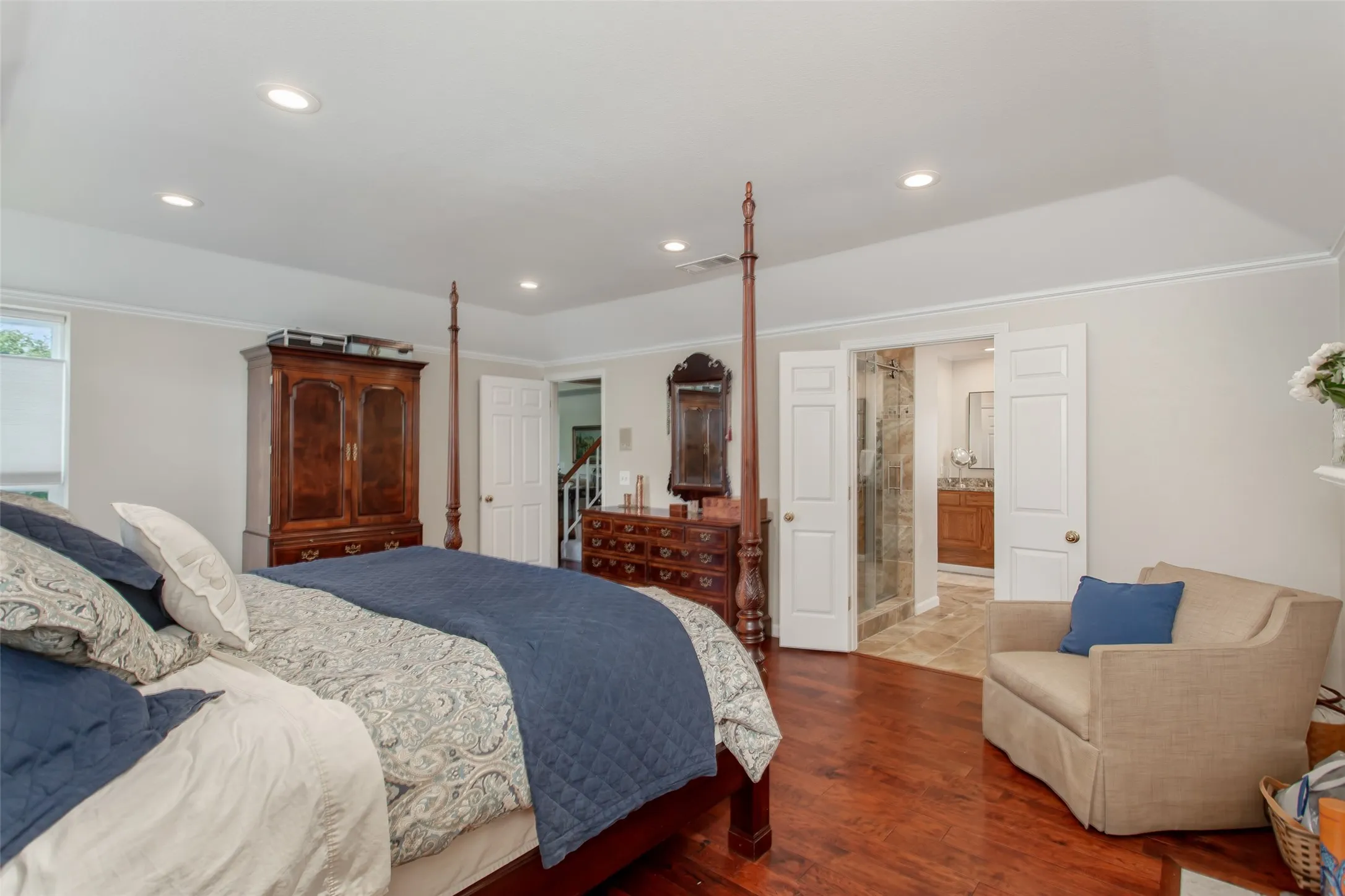Hardwood-finish flooring with recessed lighting and a tray ceiling