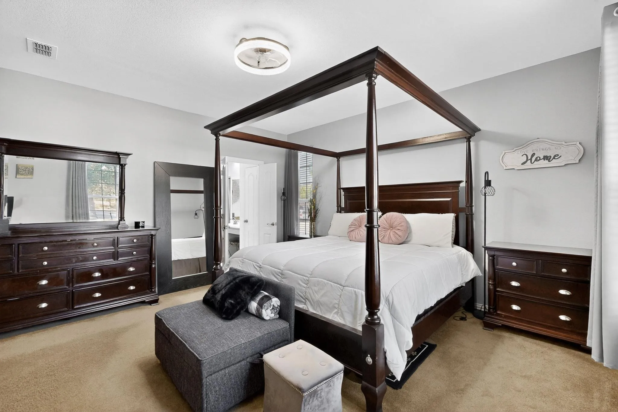 Carpeted bedroom featuring light gray walls and a ceiling-mounted light fixture