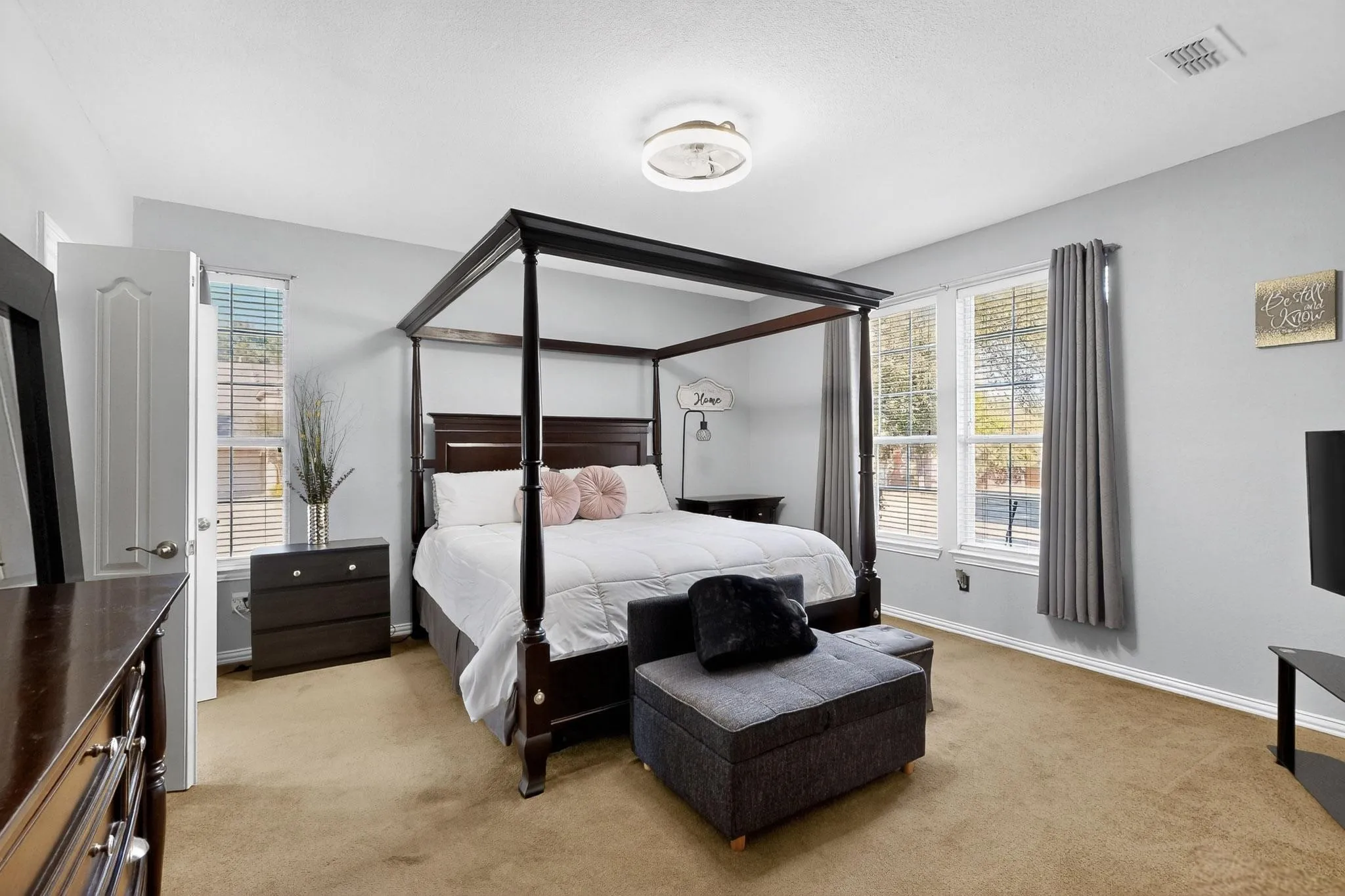 Carpeted room featuring light gray walls, white trim, and a semi-flush ceiling light fixture
