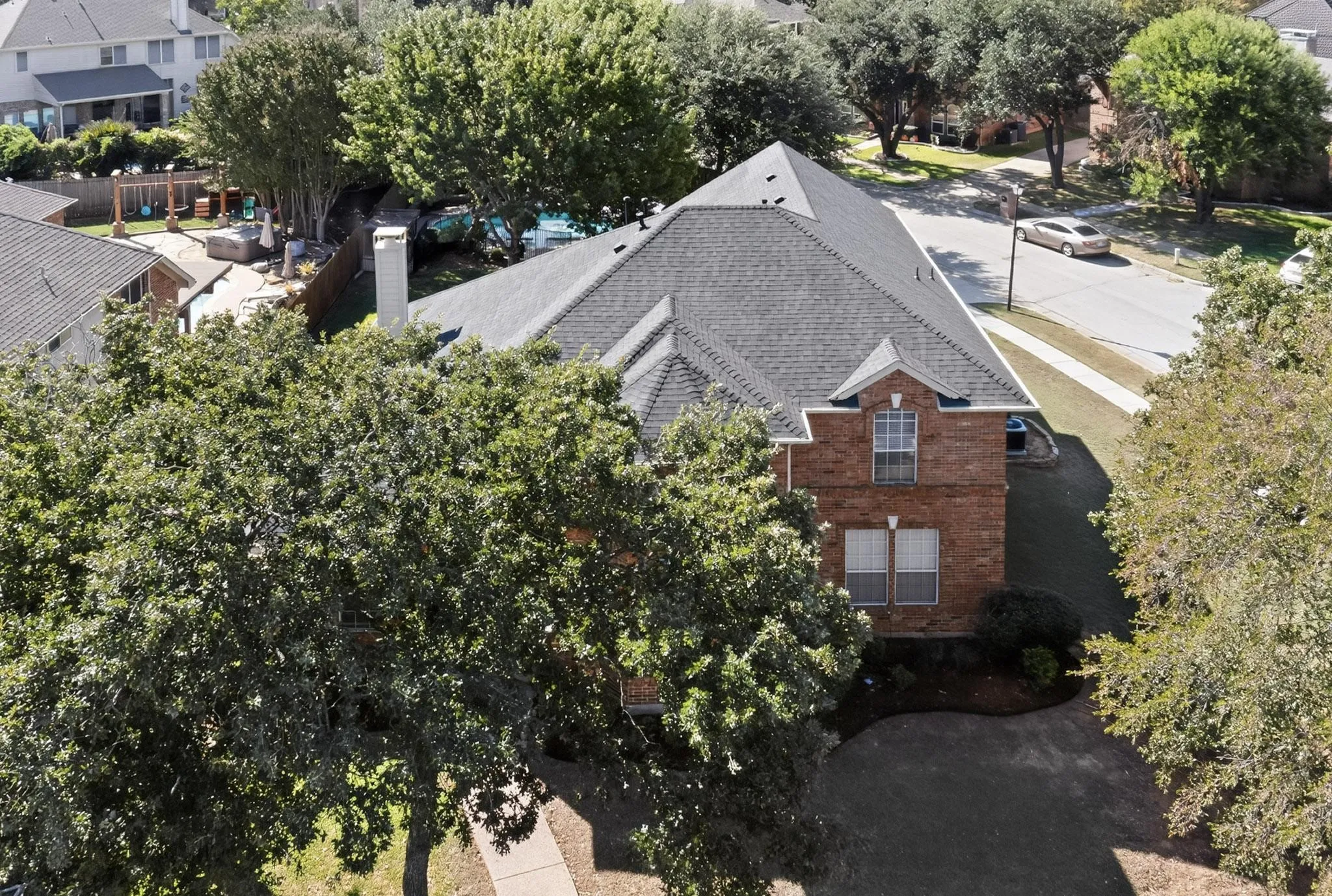 Traditional brick exterior featuring a multi-gabled roofline and prominent chimney