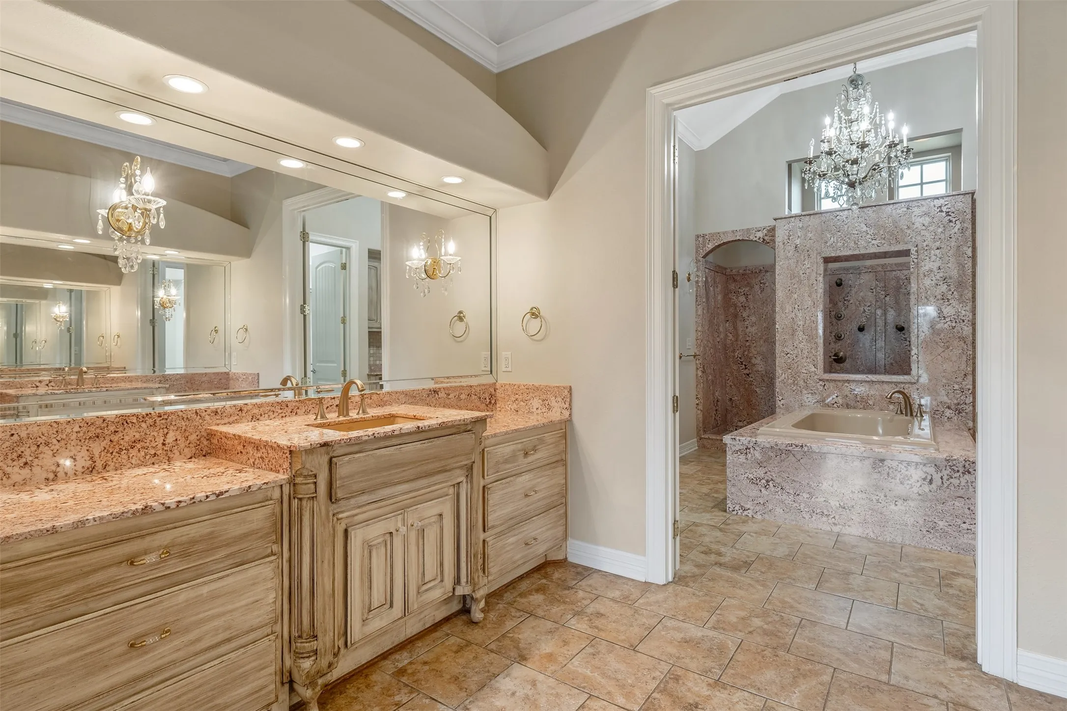 Dual vanity with light wood-finish cabinetry and granite countertops