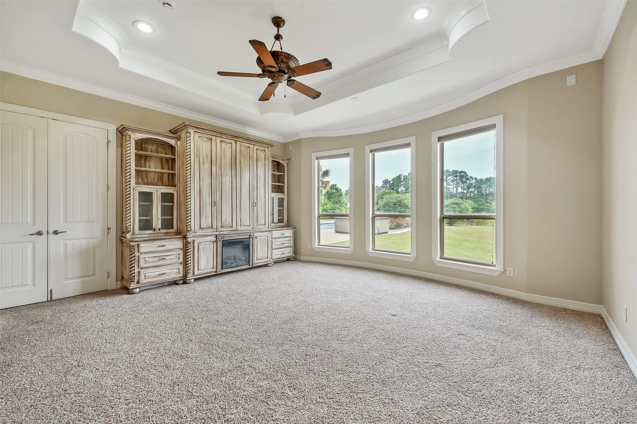 Tray ceiling with recessed lighting and crown molding