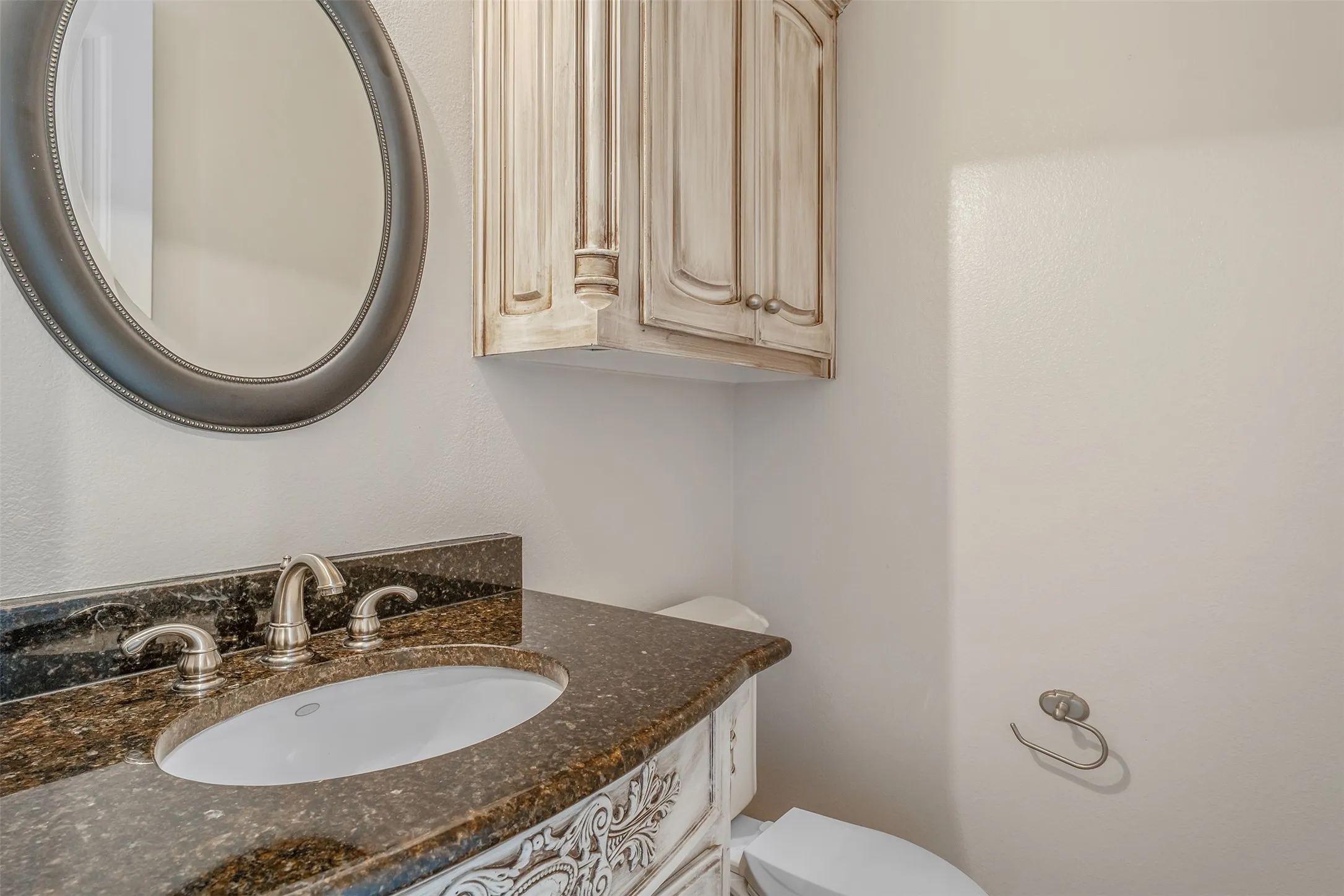 Granite countertop vanity with an undermount sink and brushed nickel faucet