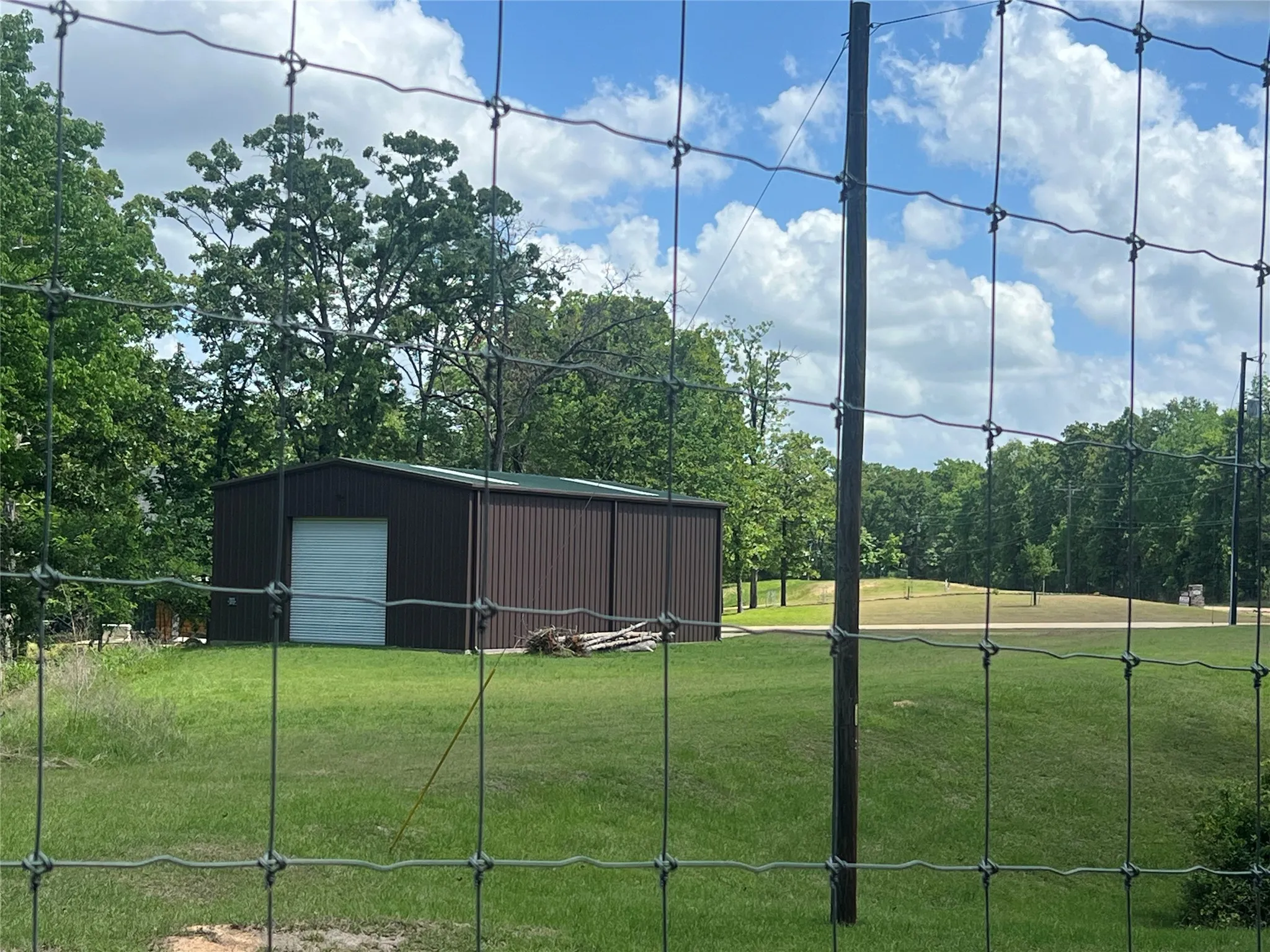 View of the side of the structure from inside Pinnacle. Property is 1.19 acres and leads down to the lake for approximately 64' of water frontage per HCAD.