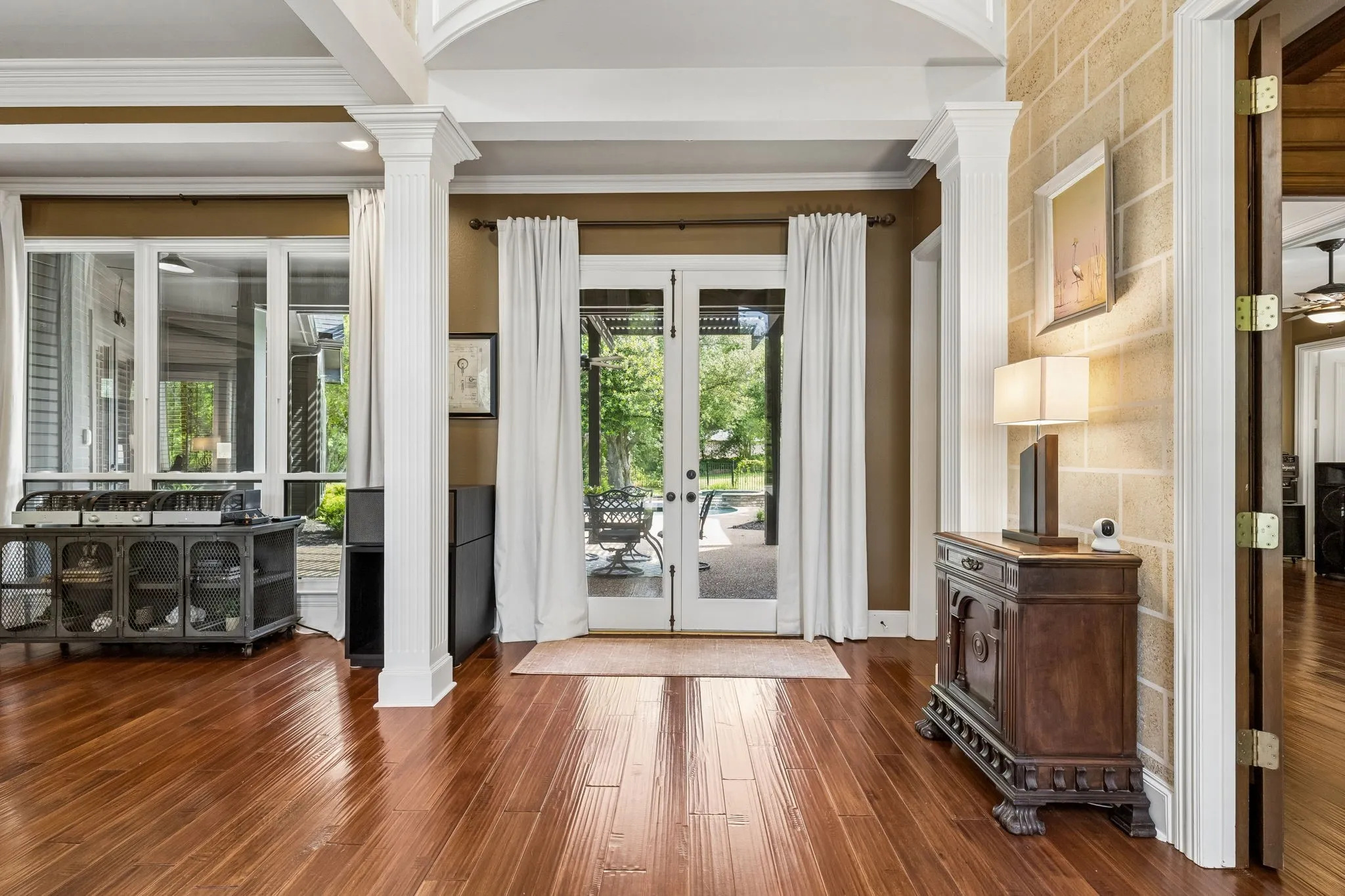Inviting two-story foyer with immediate views to the tranquil backyard beyond.