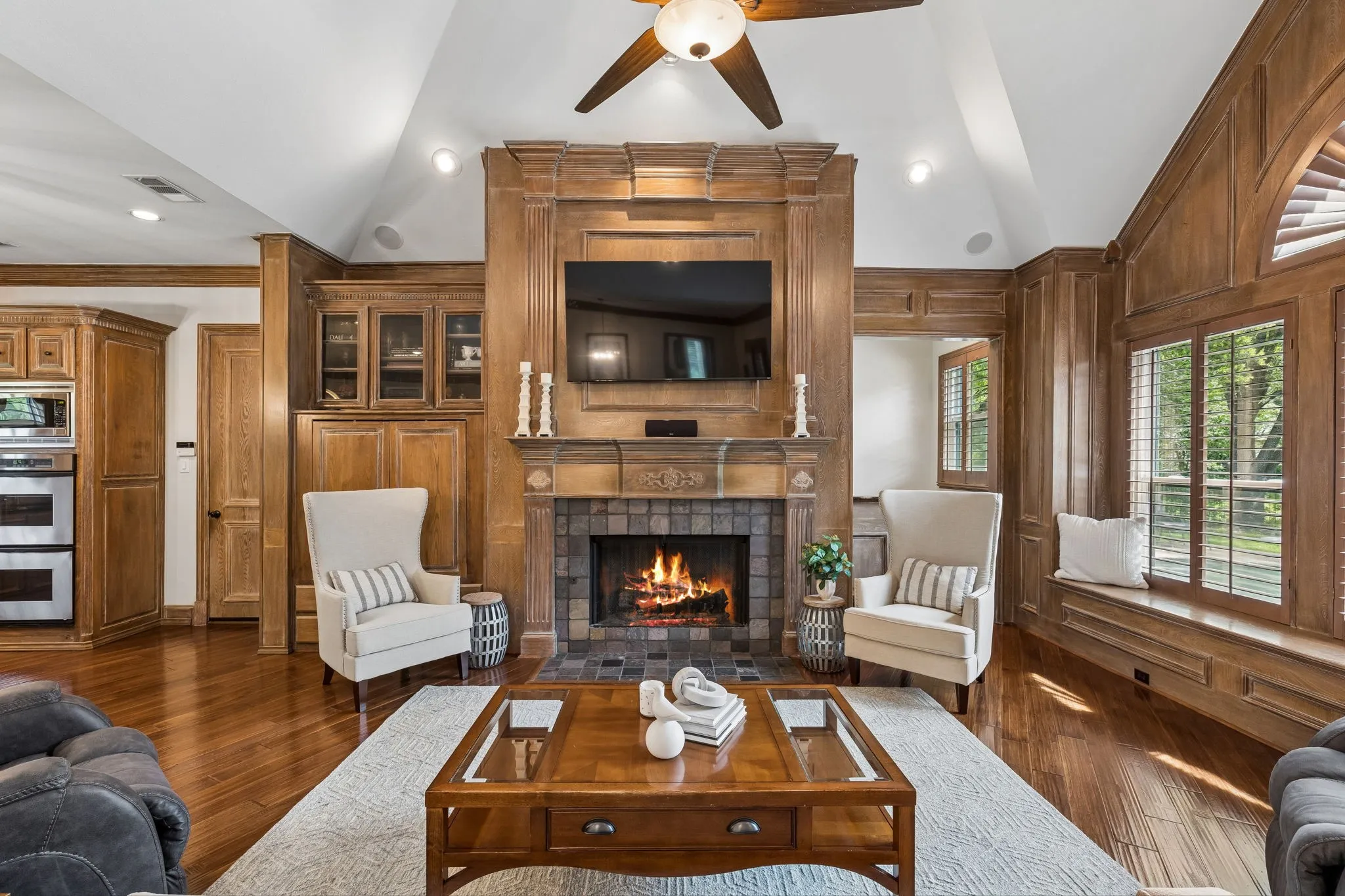 Elevated architectural design with soaring ceilings, gorgeous hardwood floors, detailed moldings, solid core doors, plantation shutters, and quality craftsmanship throughout.