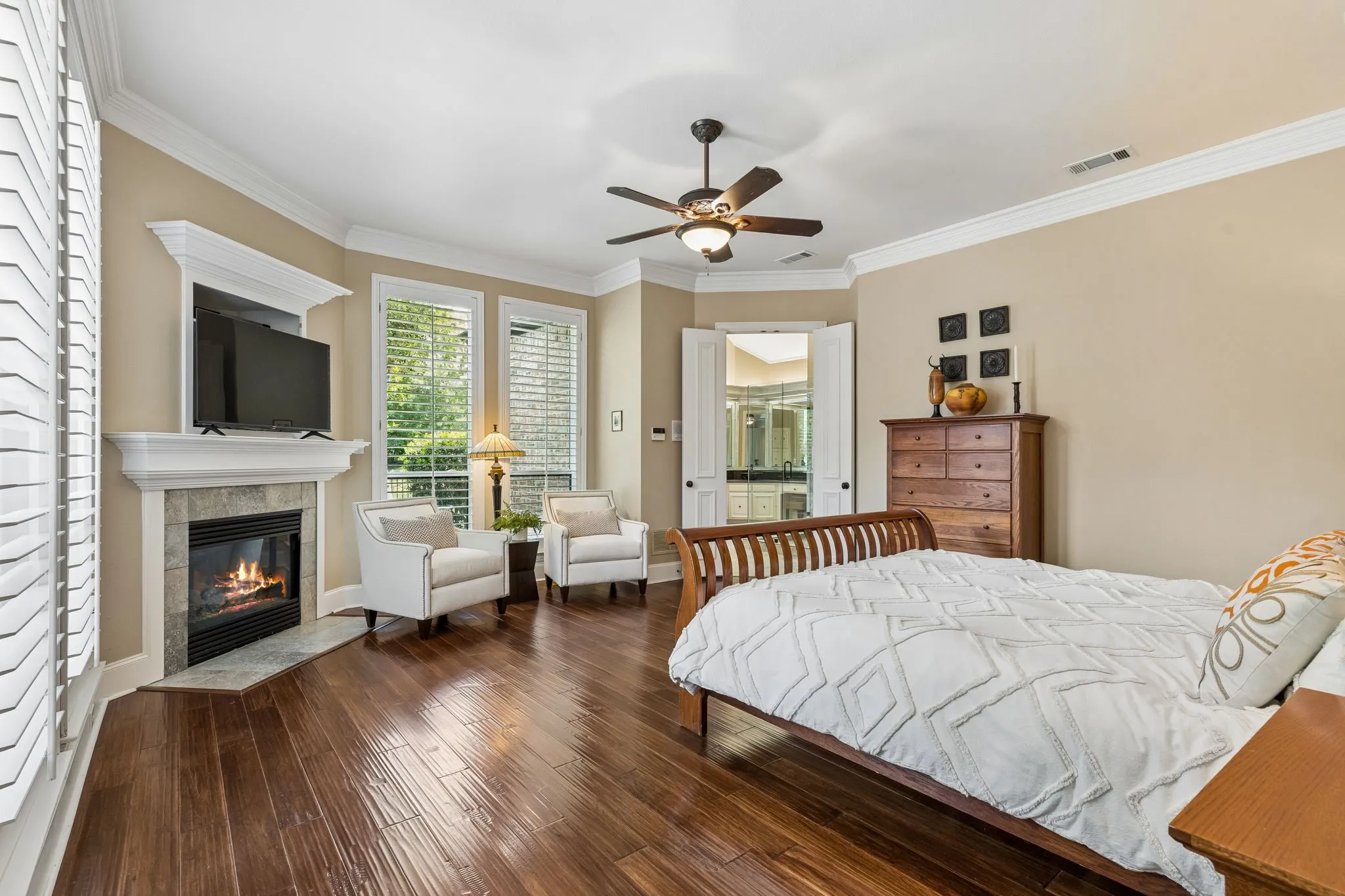 The oversized primary suite is tucked away with fireplace, sitting area, and expansive closet.