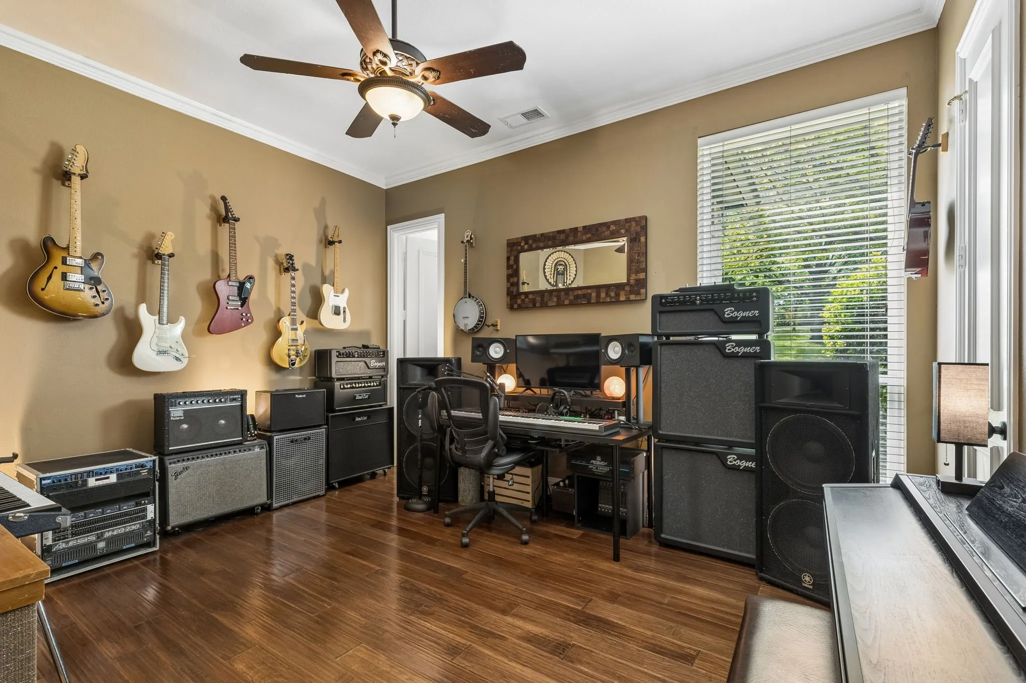 Additional first-floor guest suite with full bath, walk-in closet, and positioned for privacy. Currently being used as a music room.