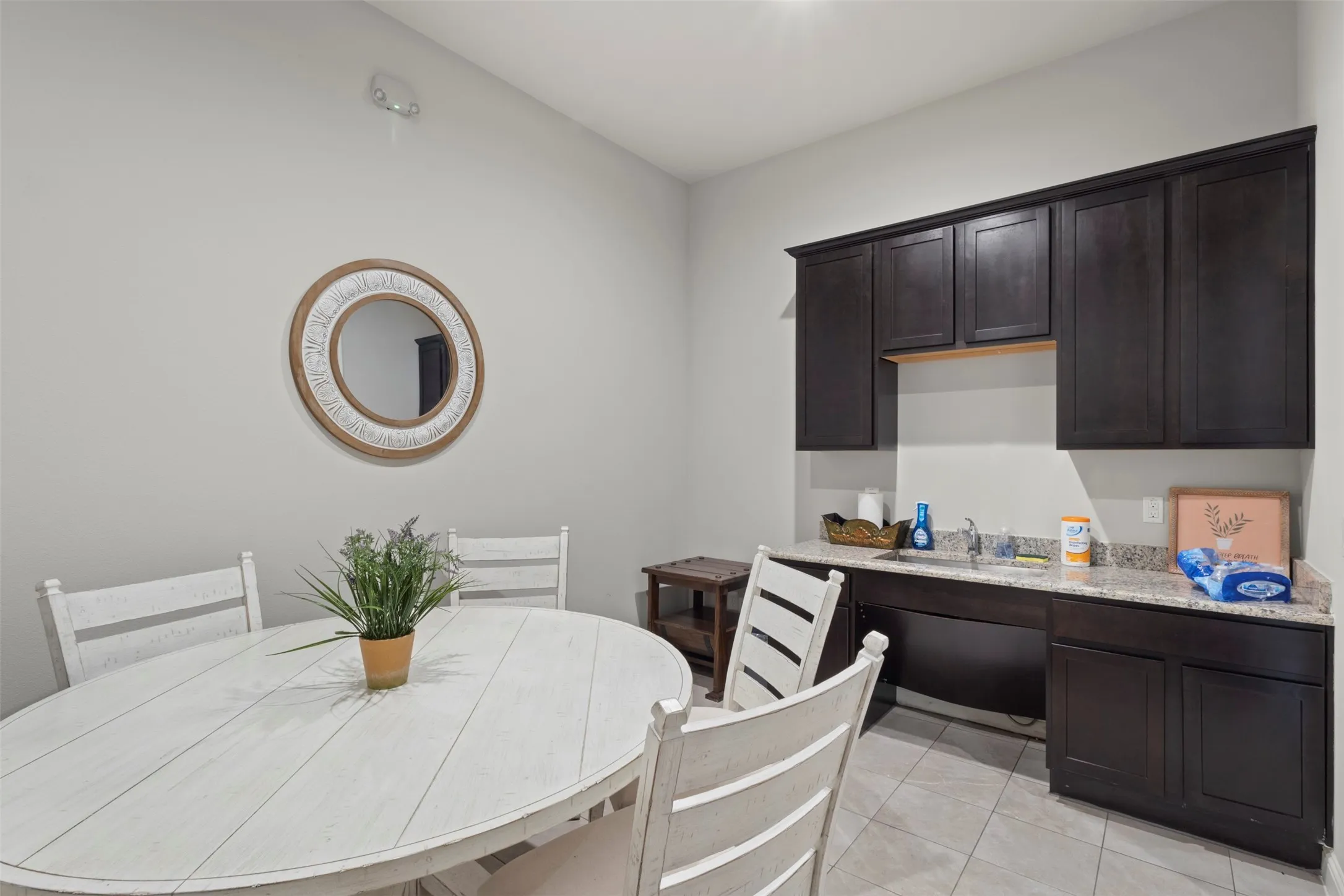Tile flooring complements dark wood-finish cabinetry and a light-toned countertop