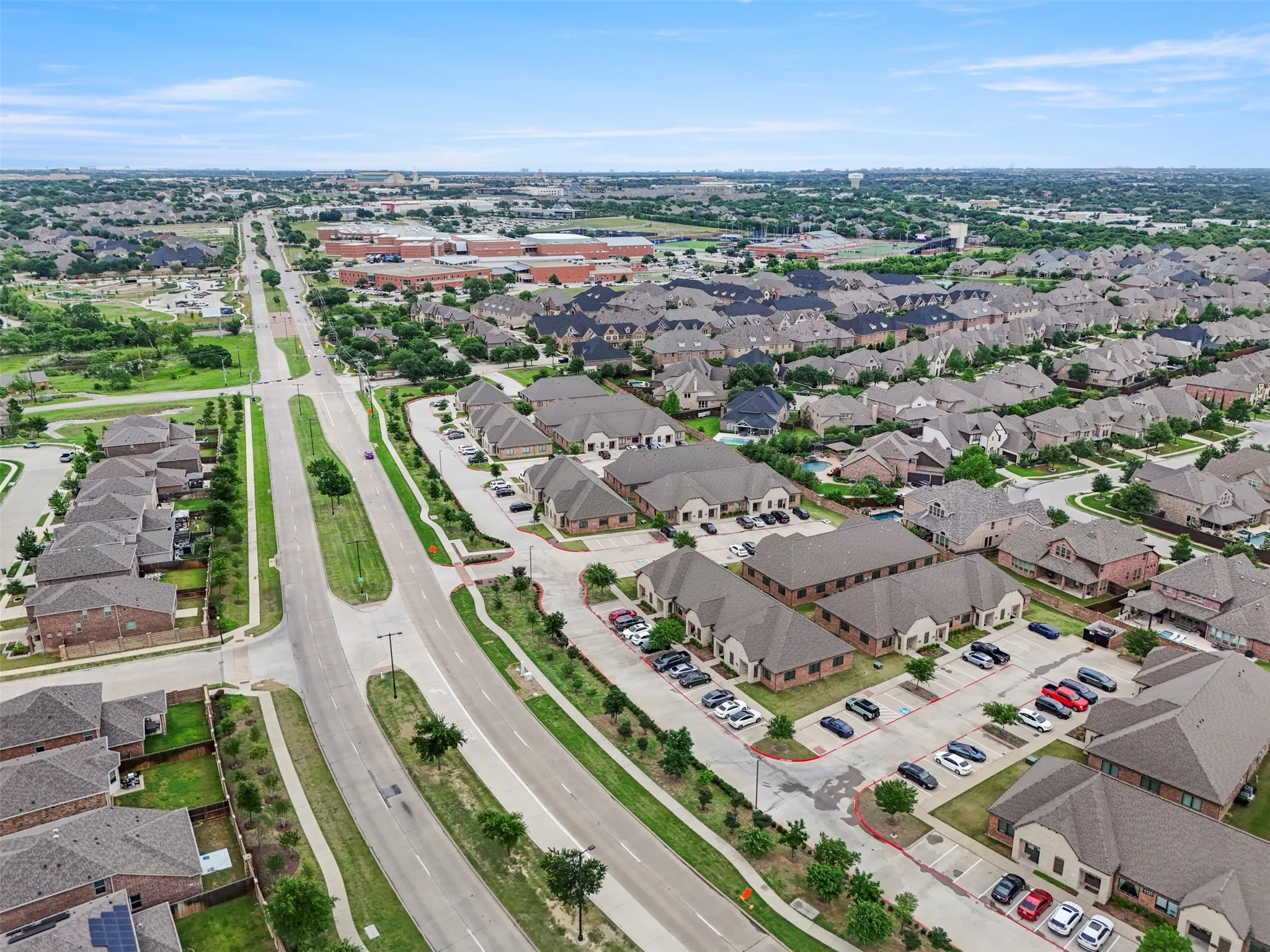 Expansive aerial perspective showcasing a residential neighborhood with varied architecture and mature trees